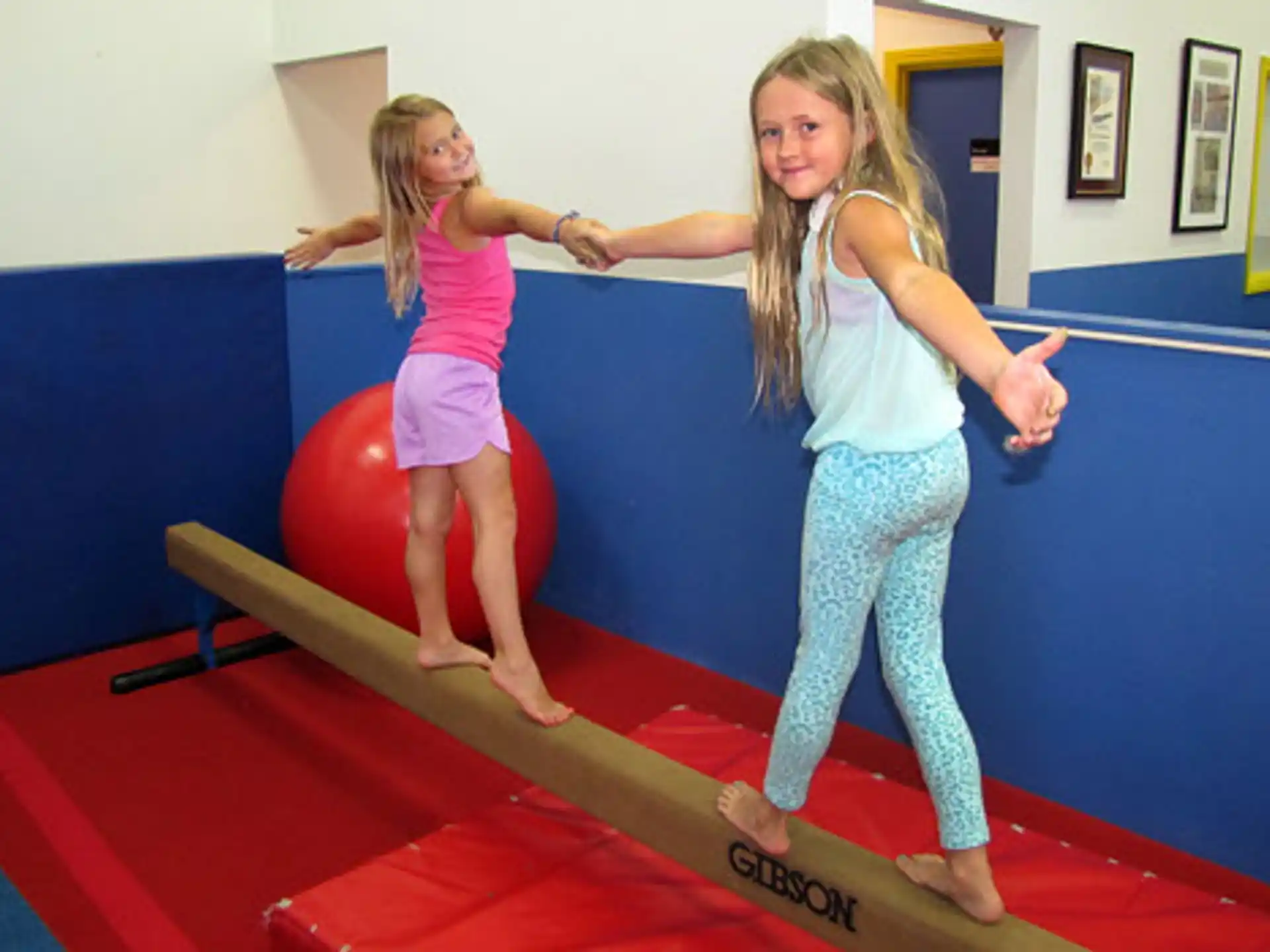 two girls on a red mat
