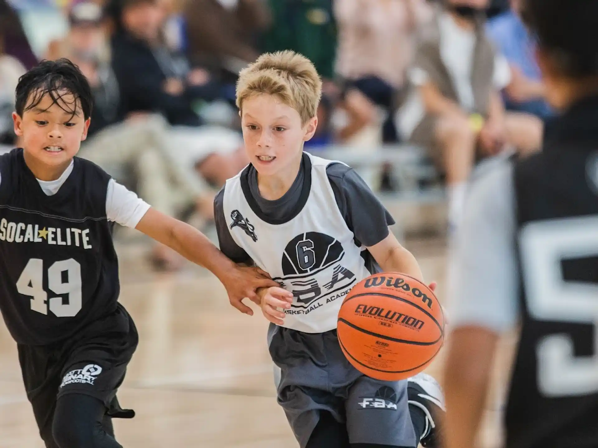 a couple of boys playing basketball