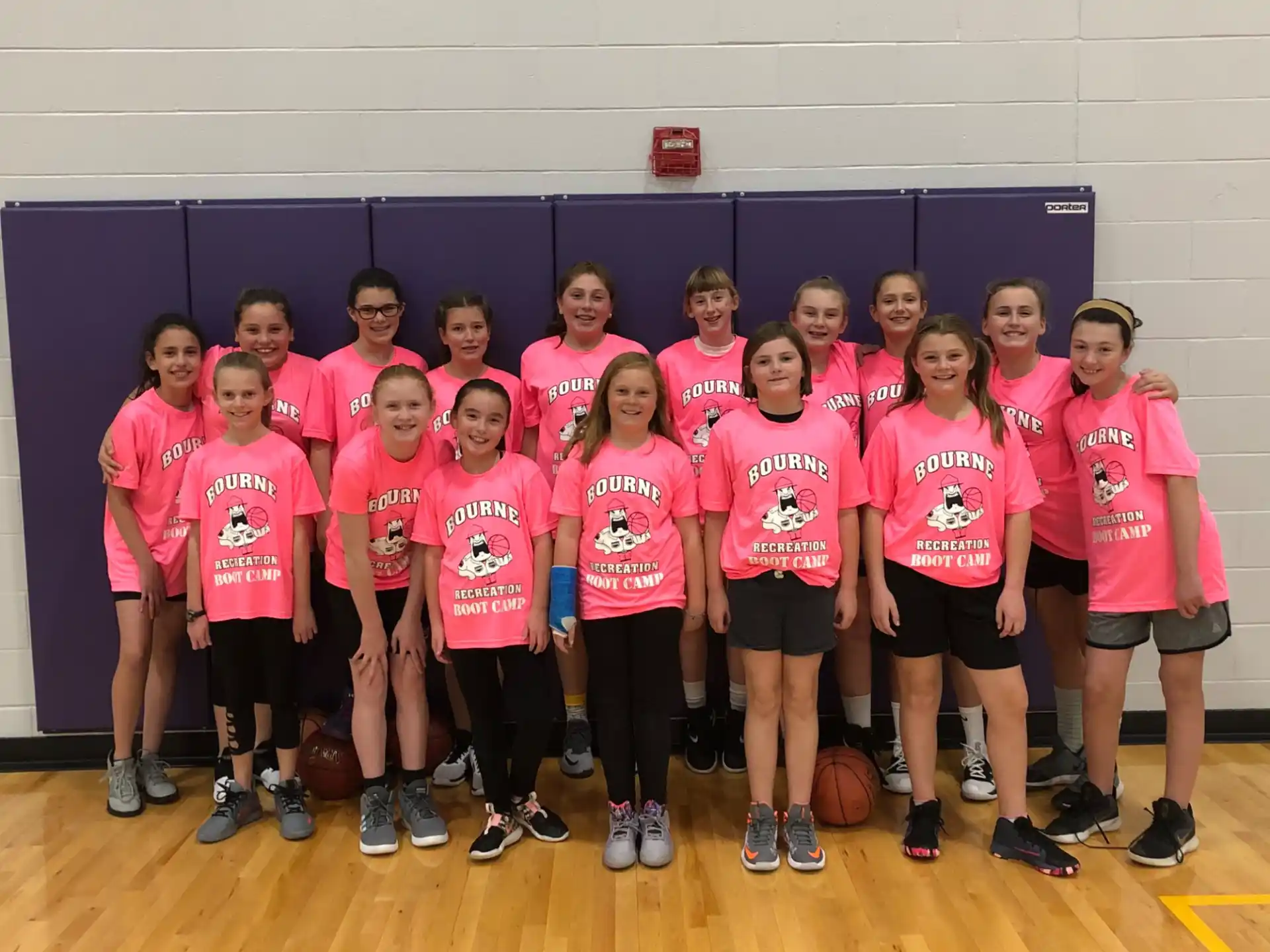 a group of girls wearing pink shirts