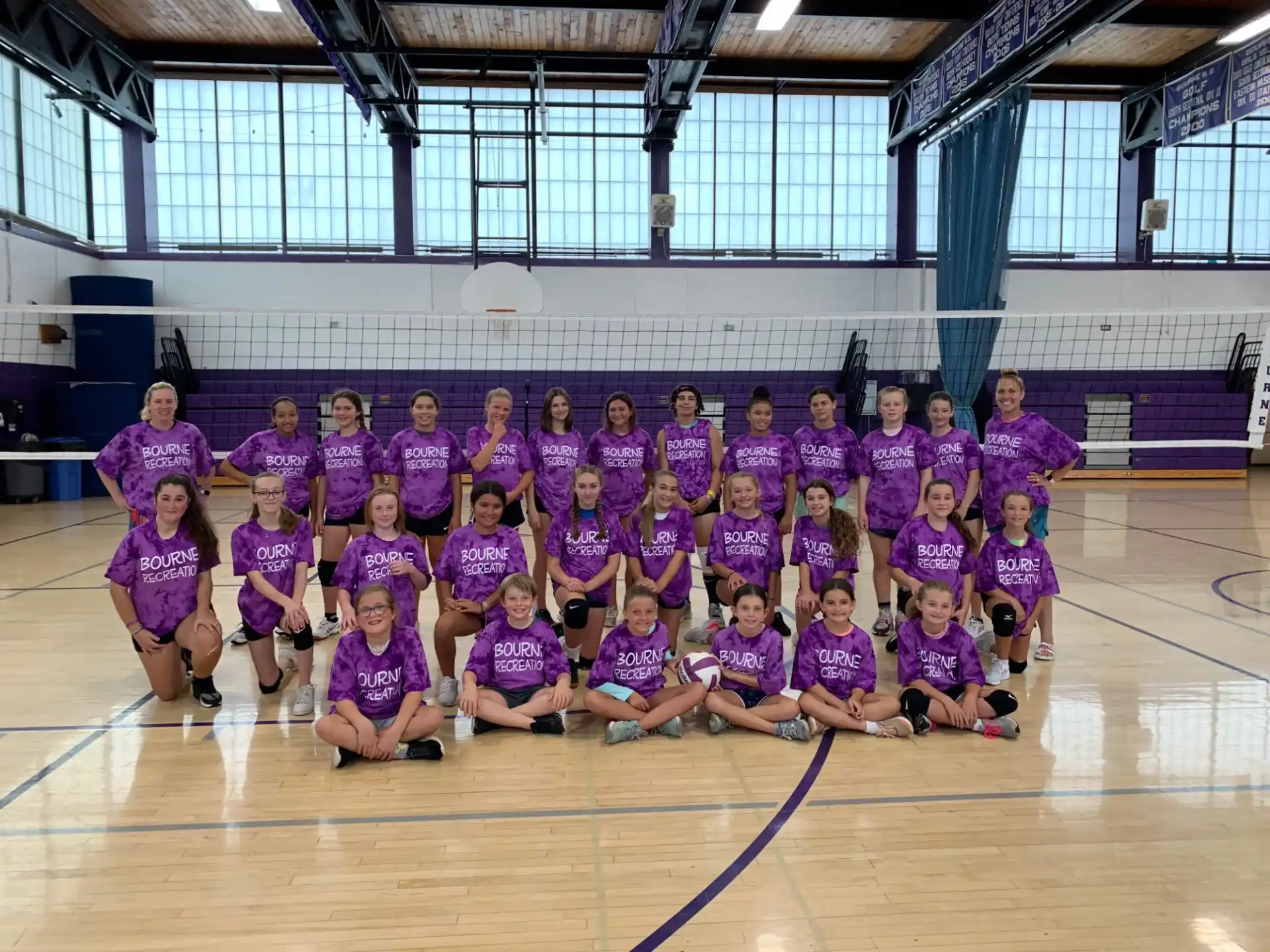 a group of people in purple shirts