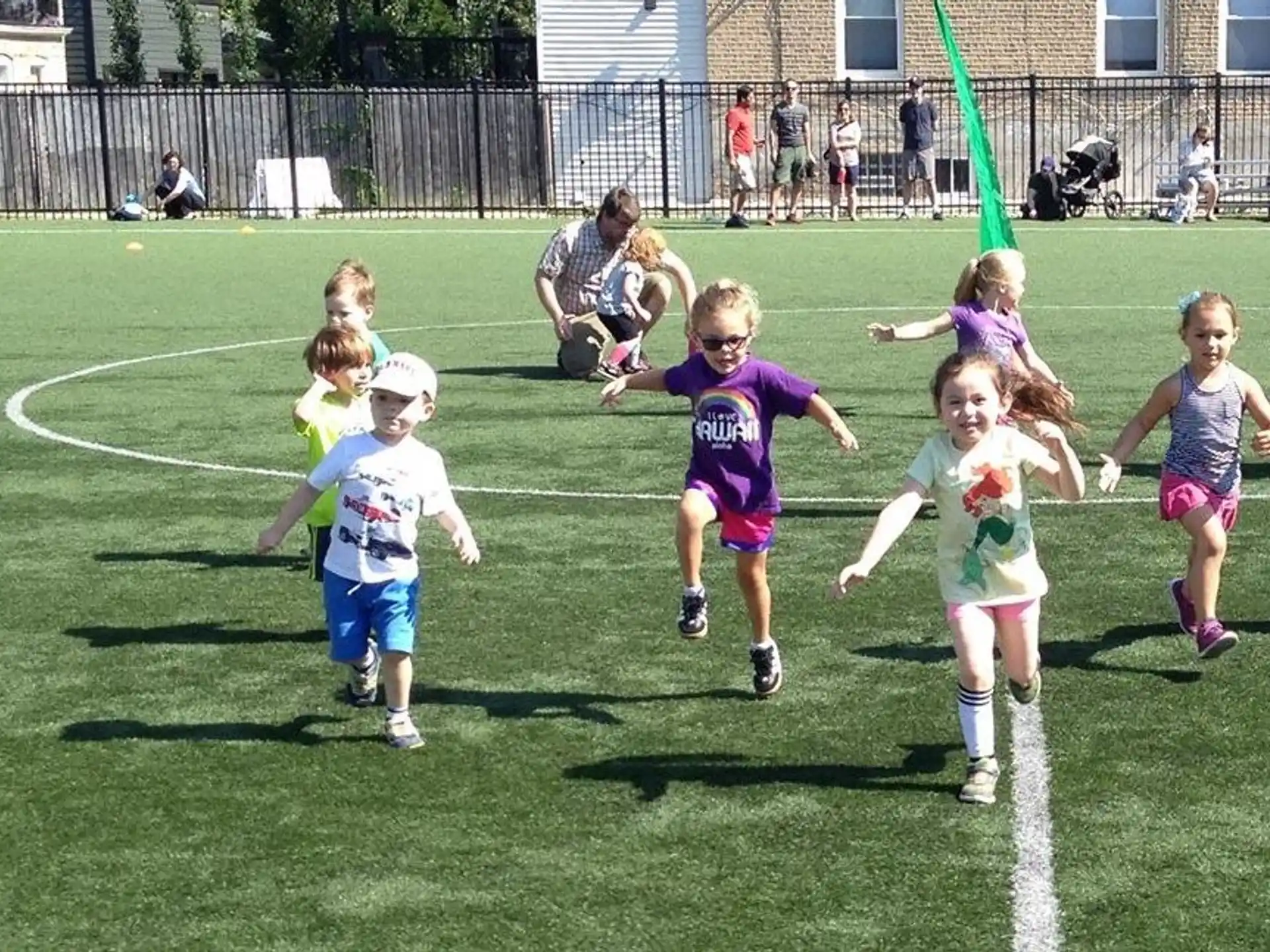a group of children running on a field
