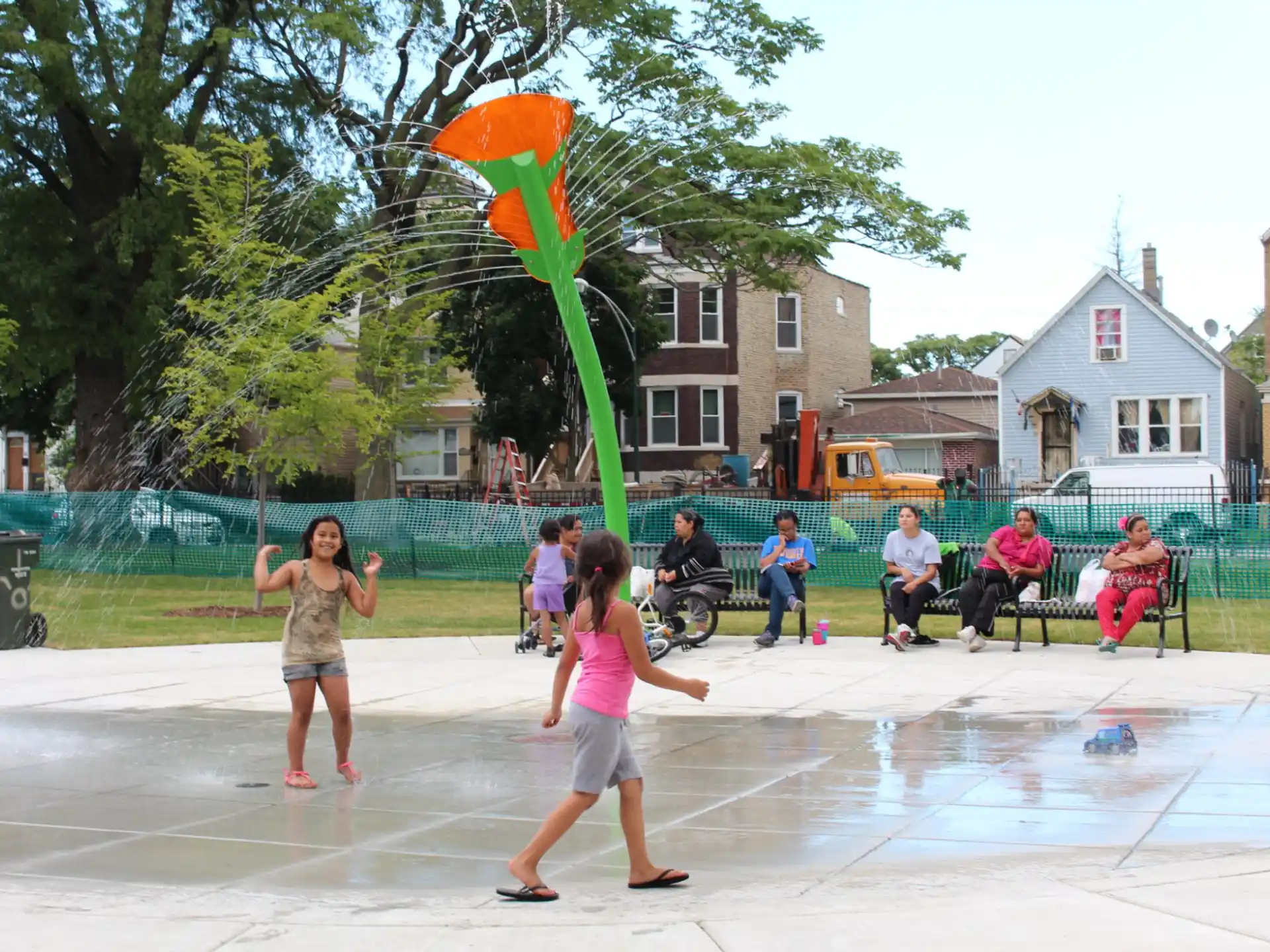 a group of people playing in a water fountain