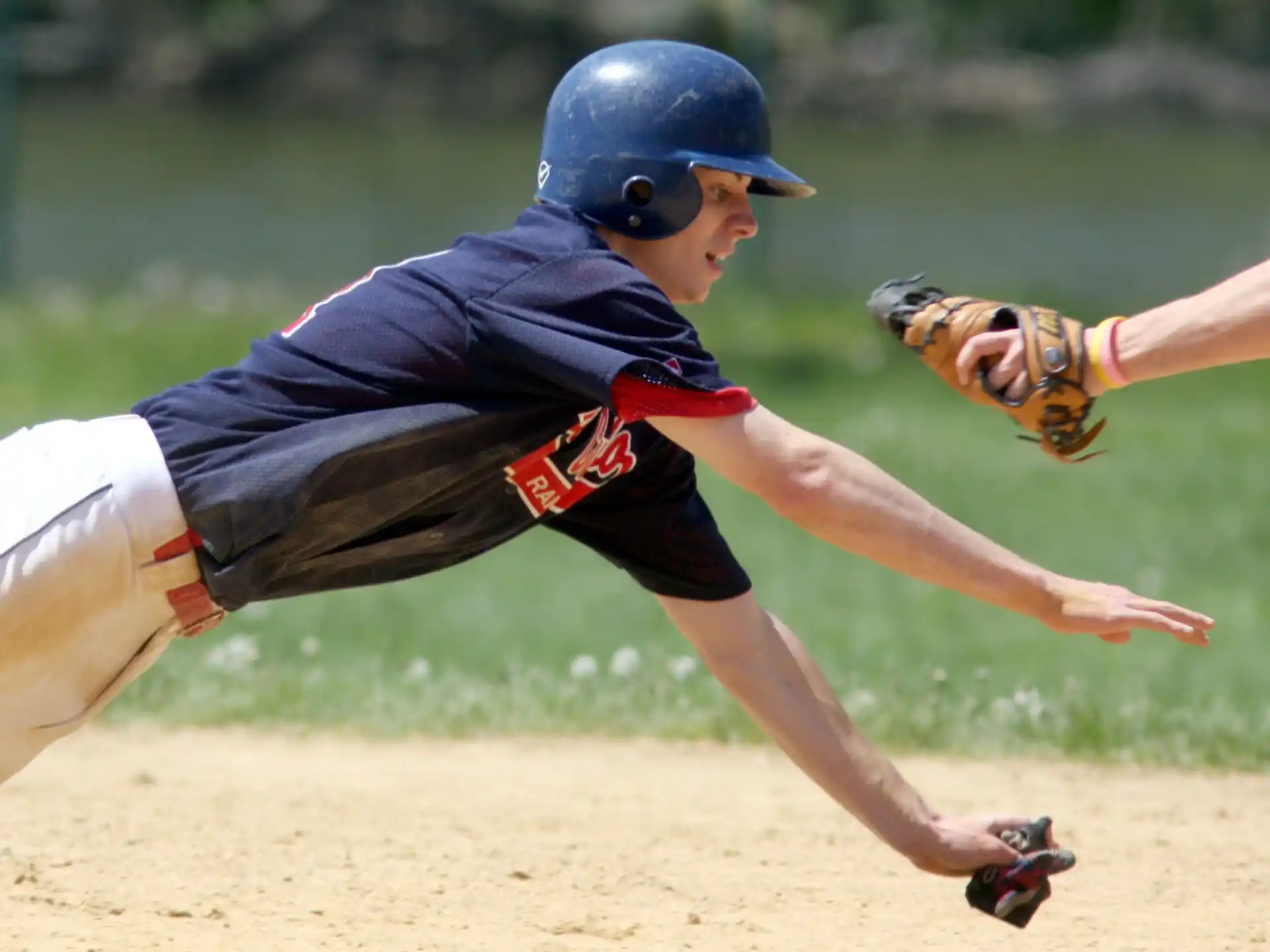 a baseball player sliding into the base