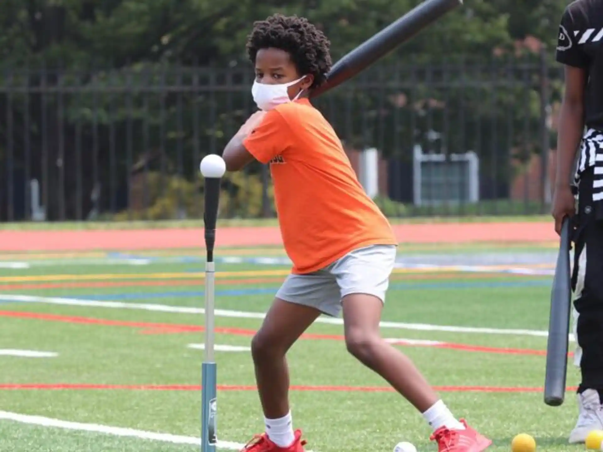 a person swinging a bat at a ball