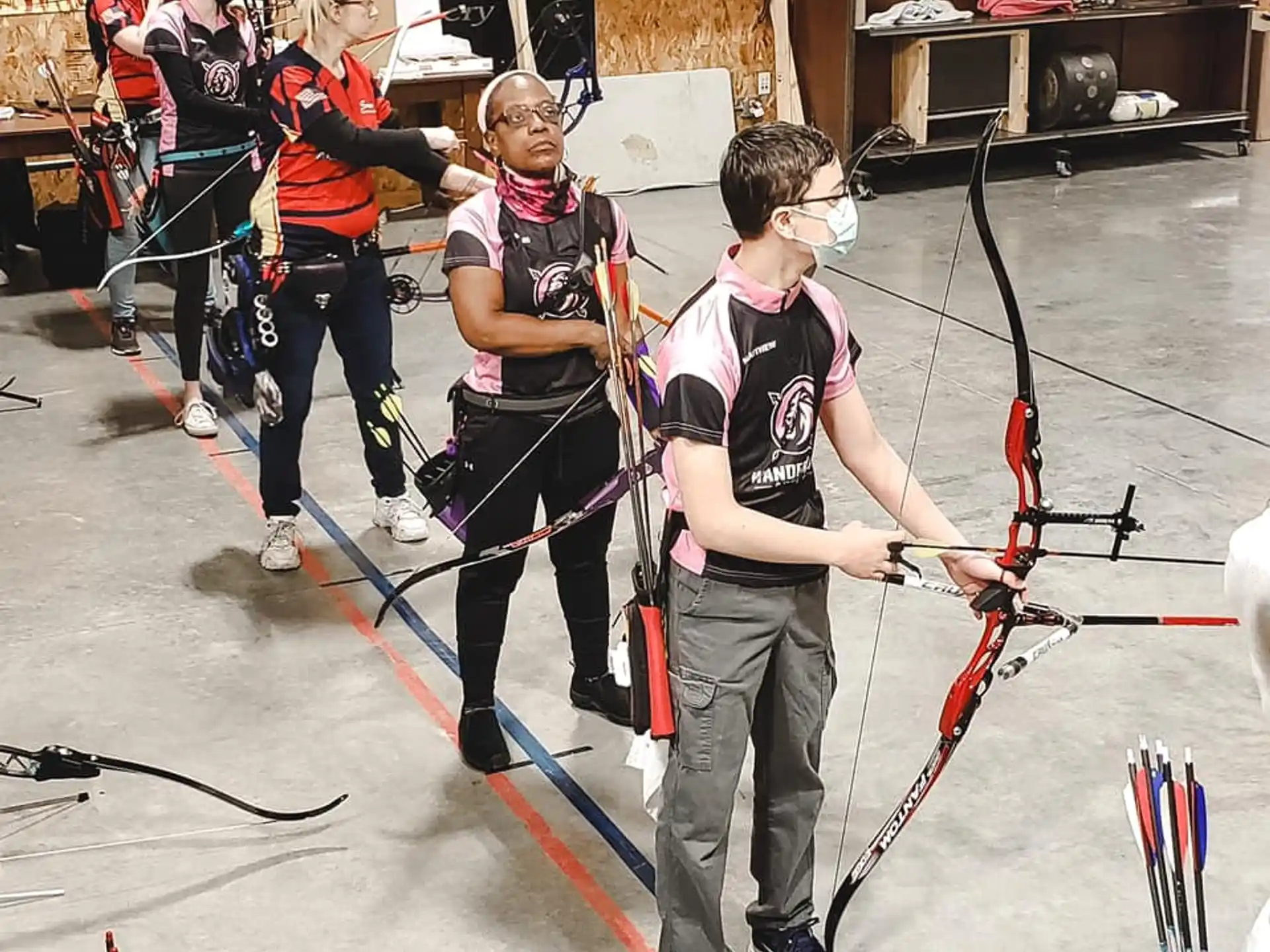a group of people holding bows and arrows