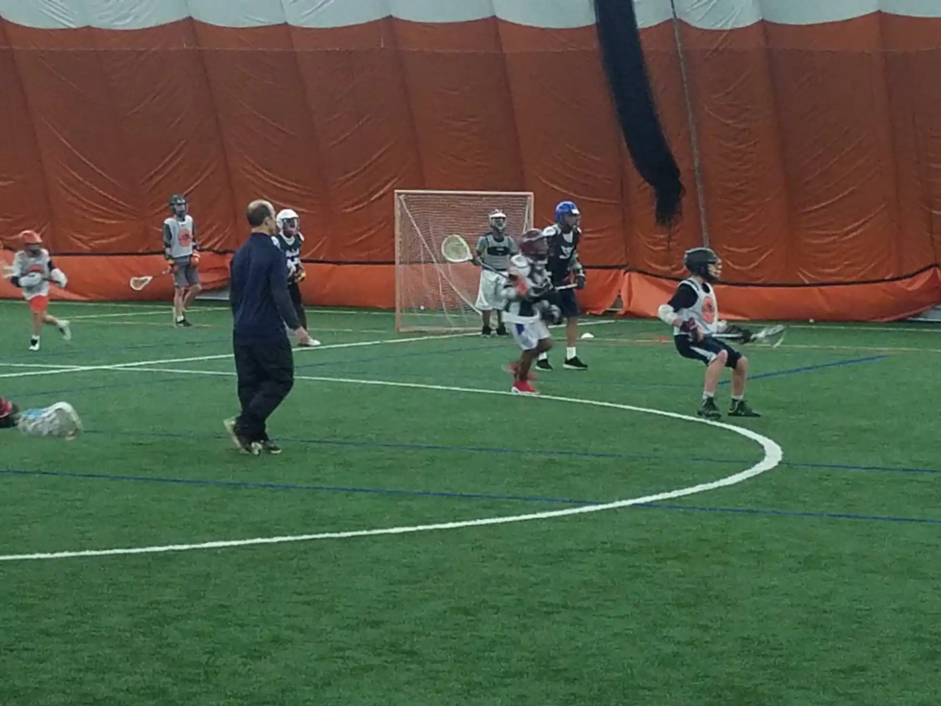 a group of people playing lacrosse