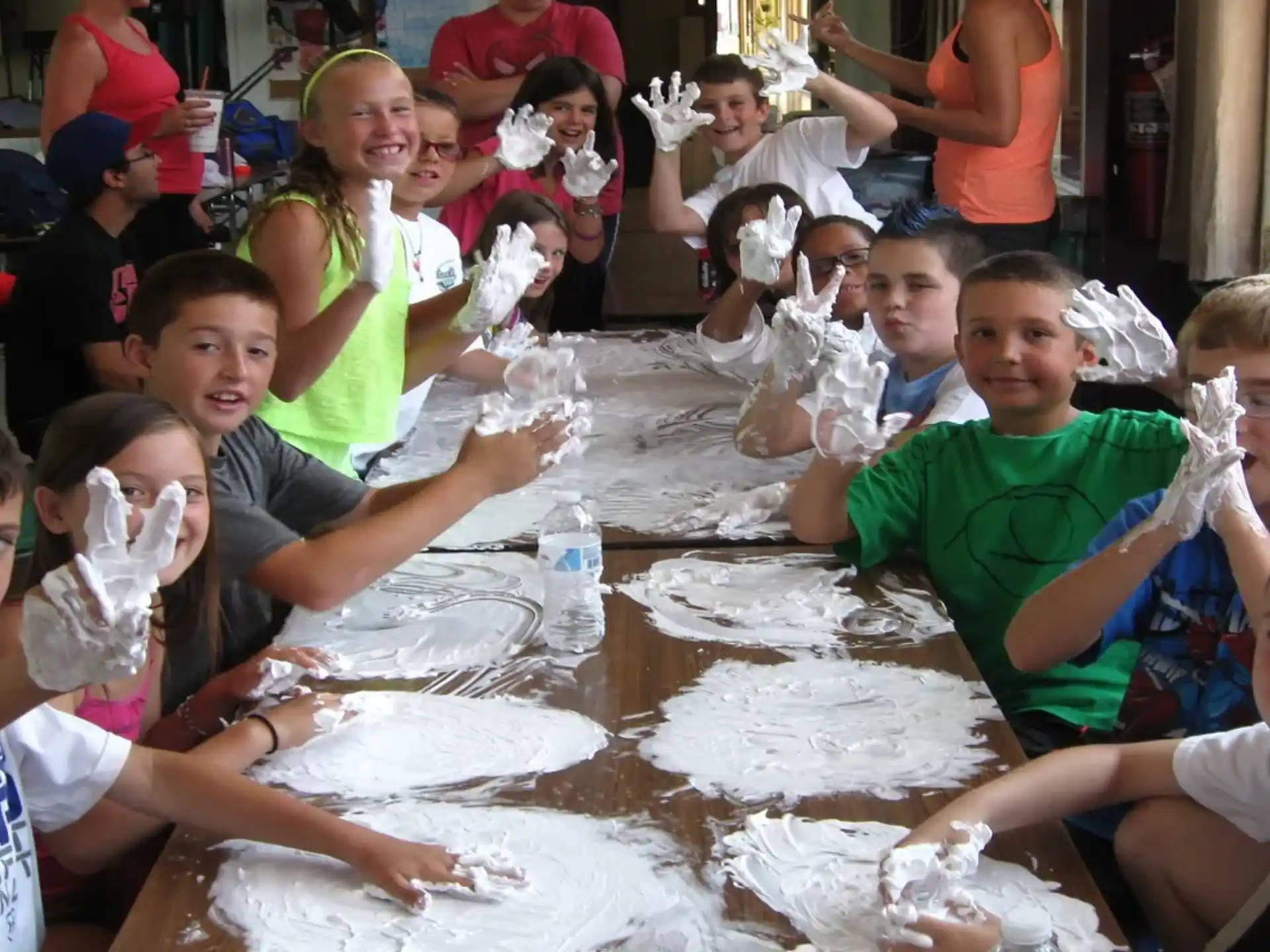 a group of children sitting around a table