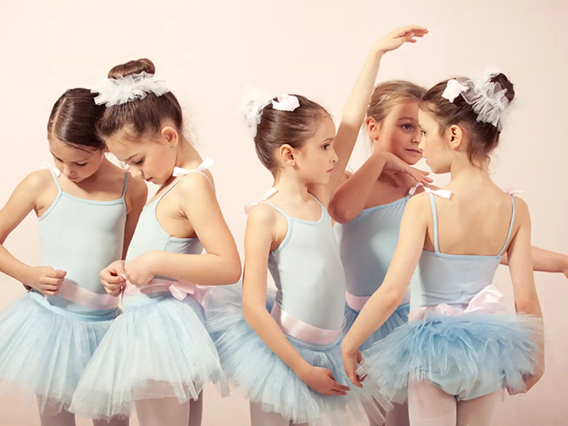 a group of girls in blue dresses