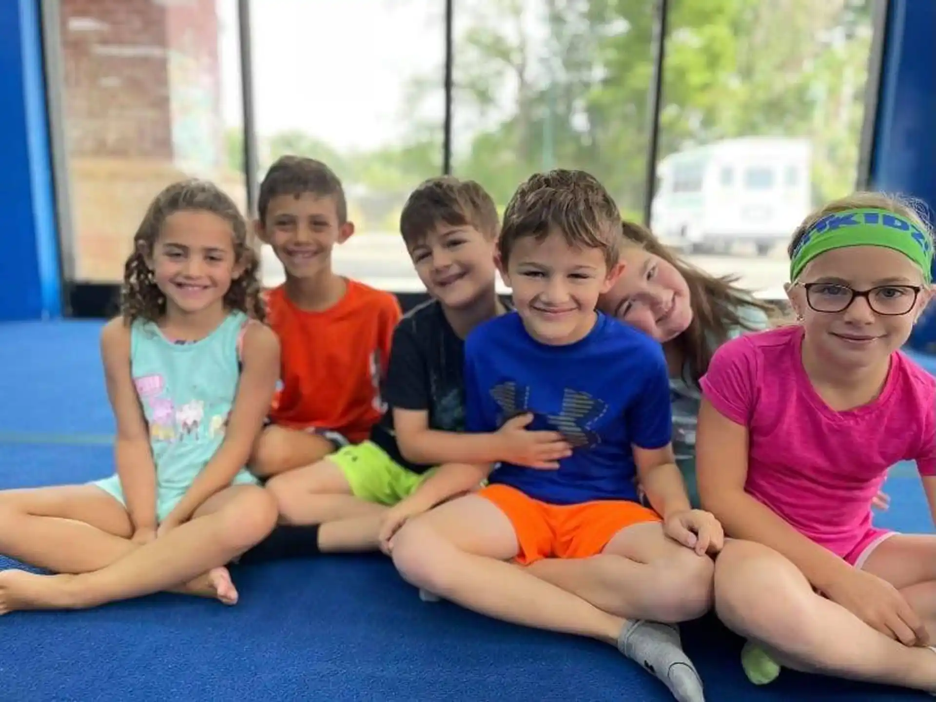 a group of children sitting on a mat