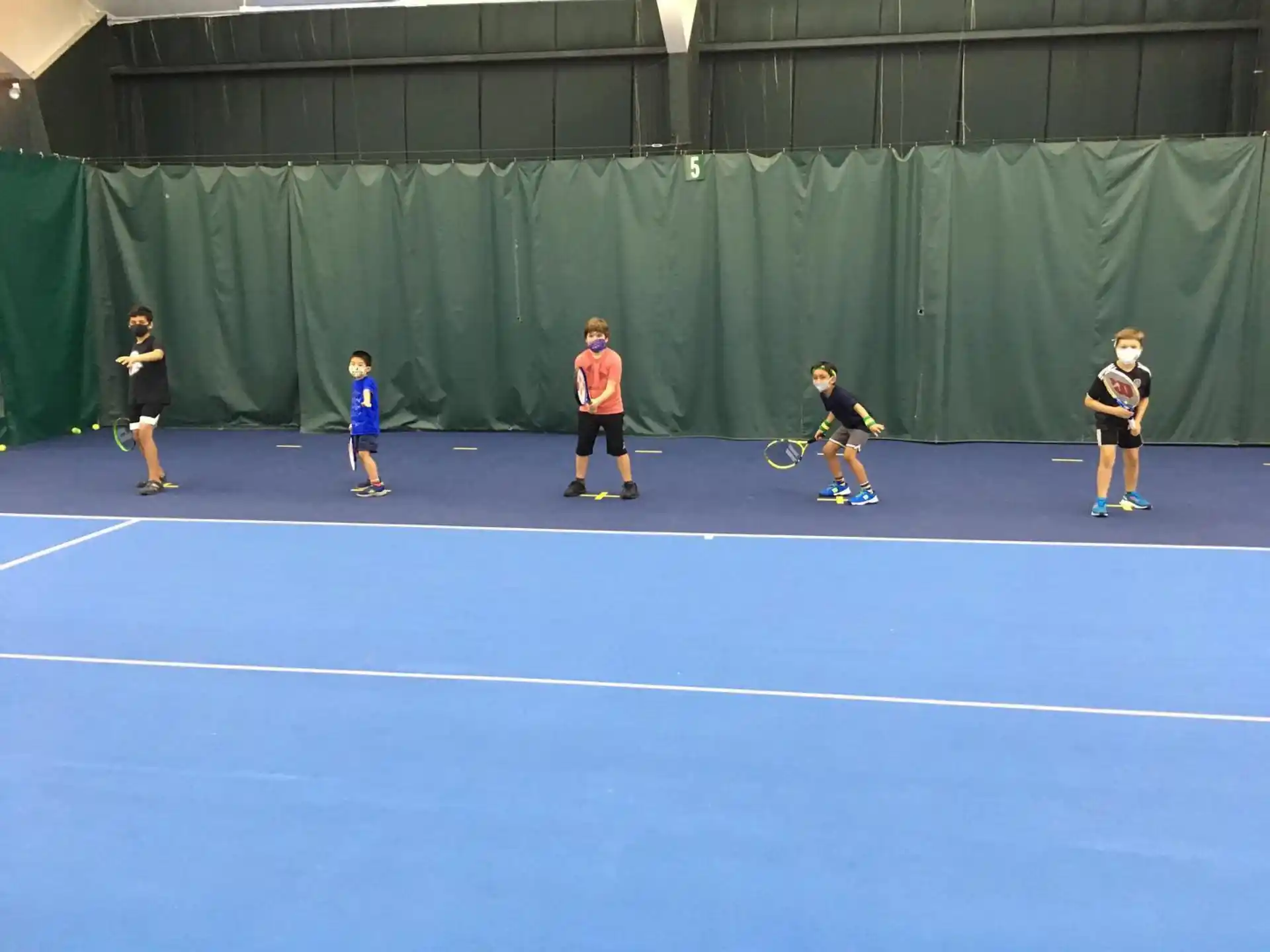 a group of people play tennis