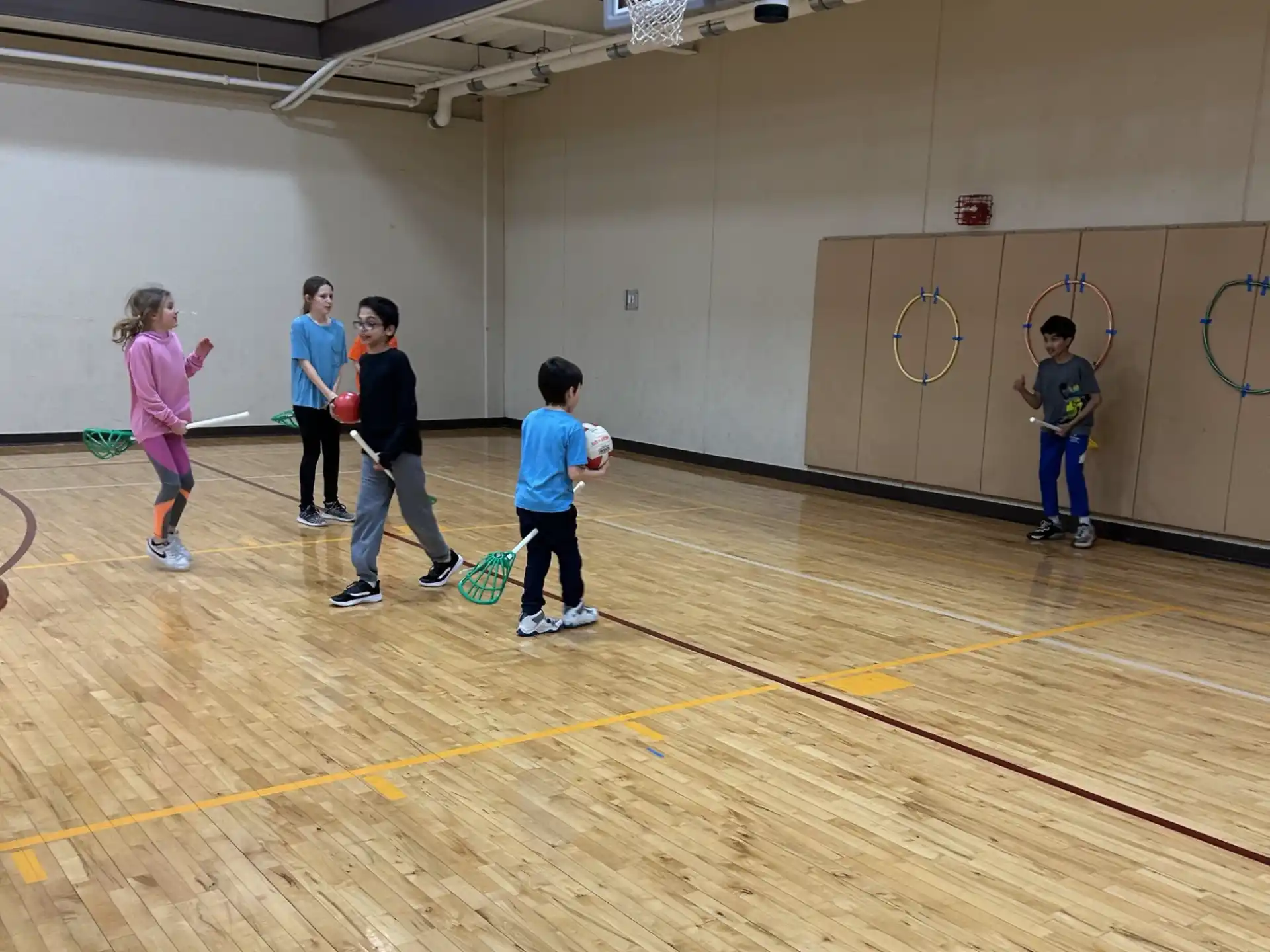 a group of kids playing basketball
