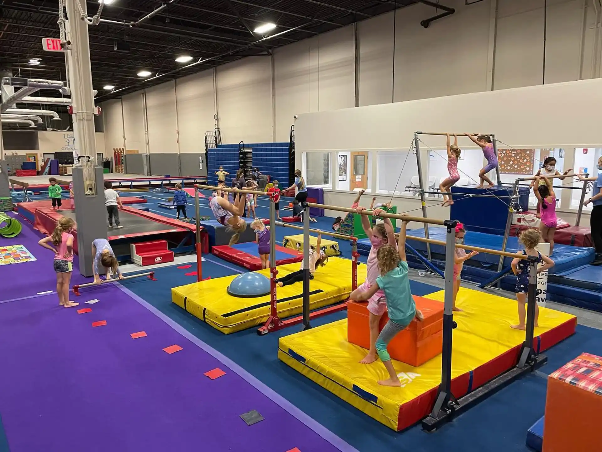 a group of people playing on a trampoline in a room
