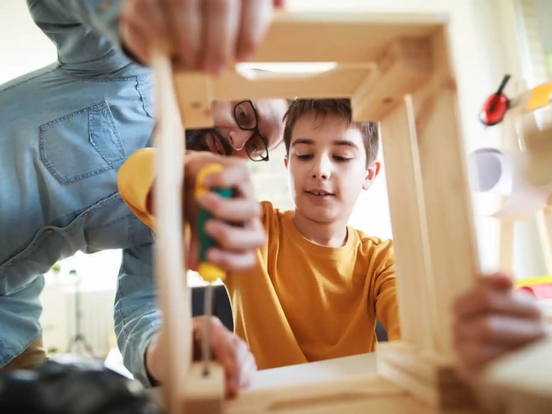 a person and a boy playing with toys