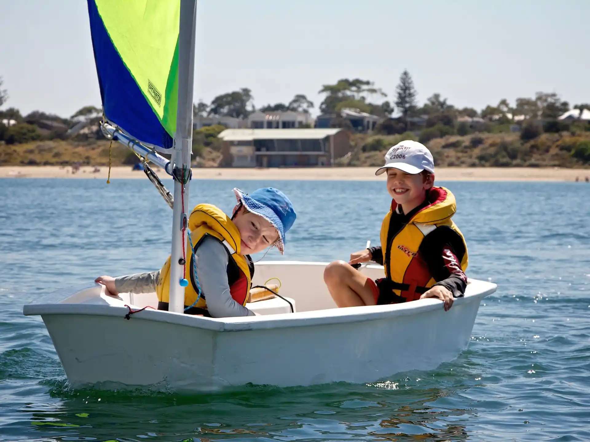 a couple of kids in a small boat on the water