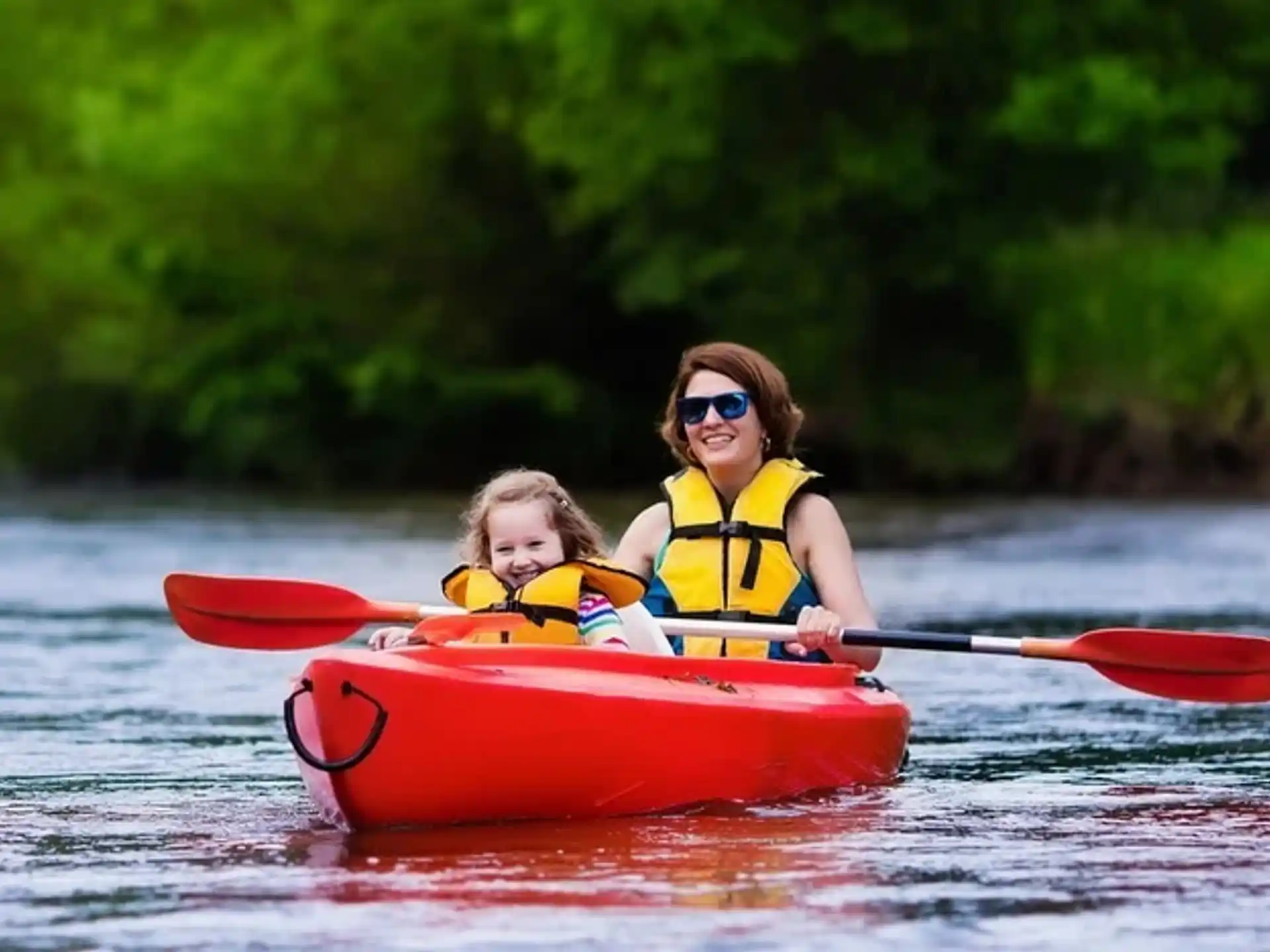 a man and a child in a canoe on a lake