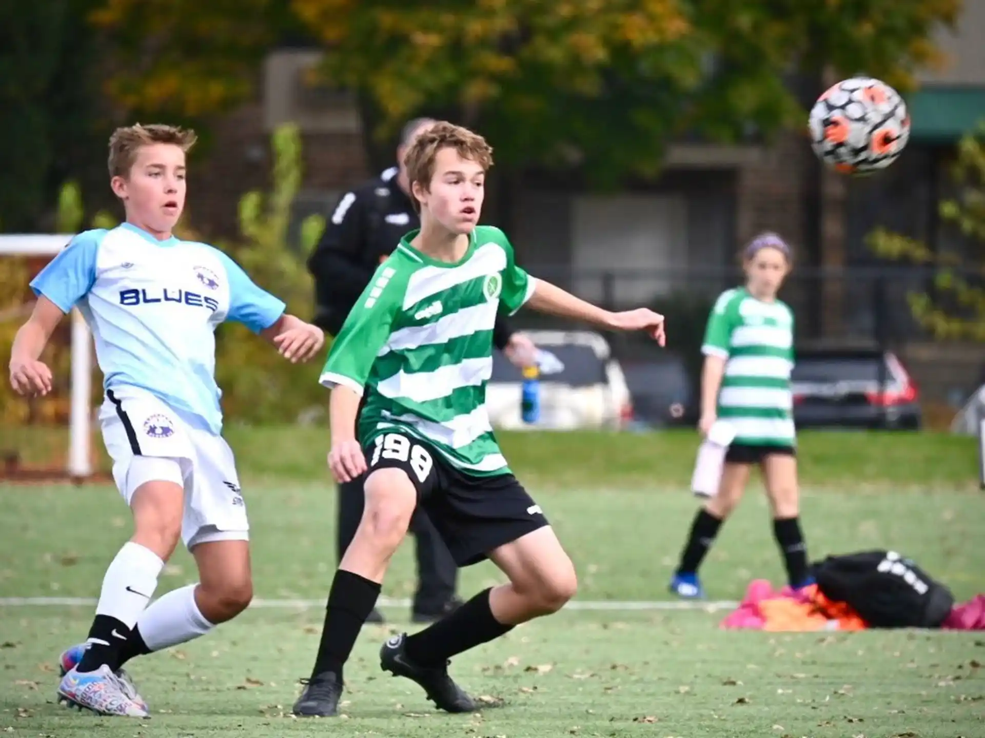 a group of kids compete in a football match
