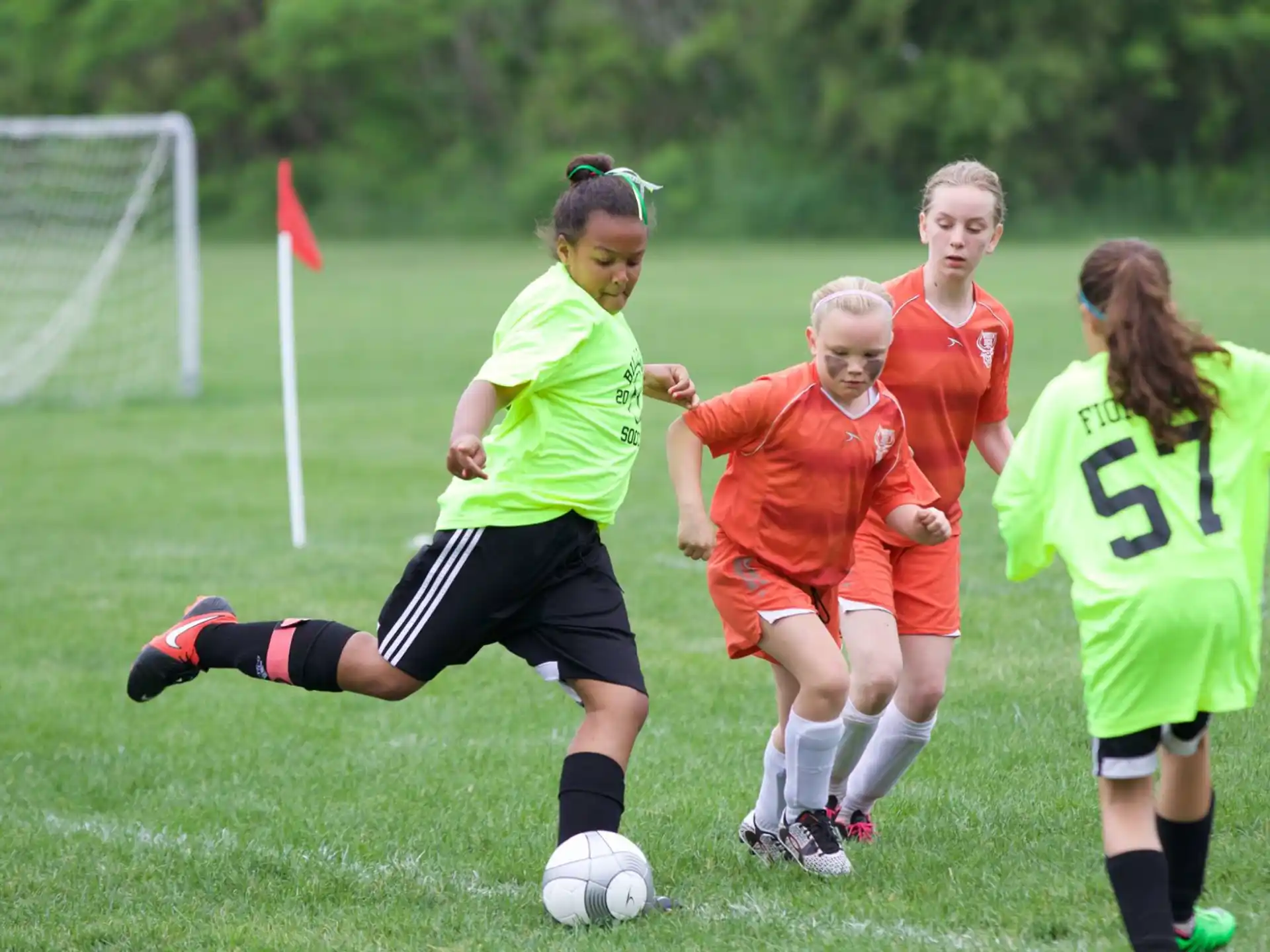 girls playing football on a field
