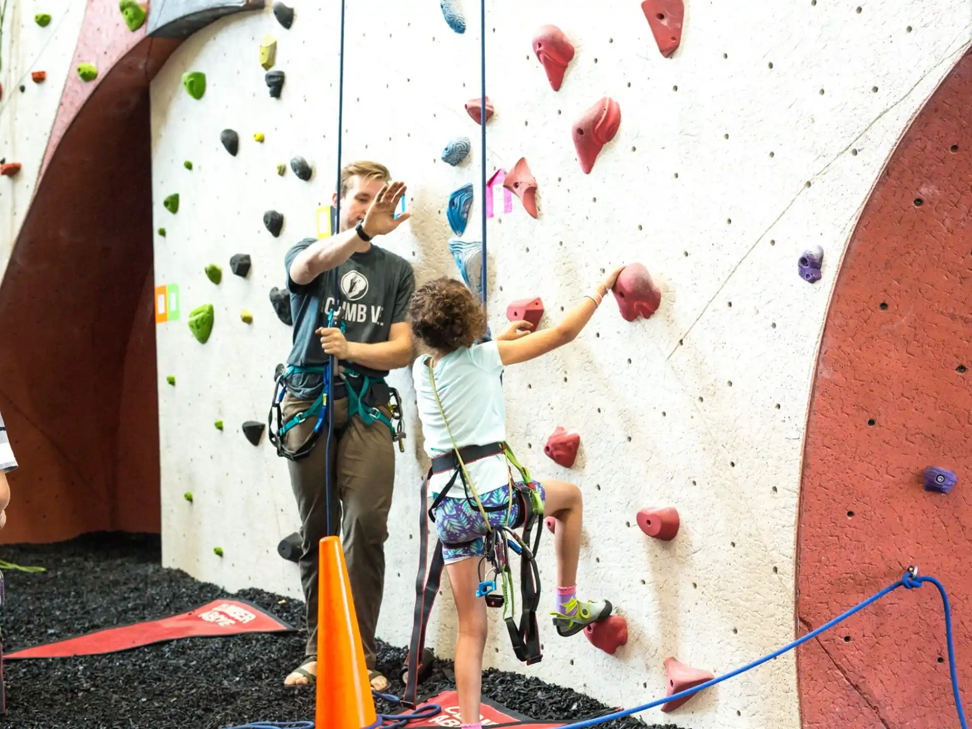 a group of people climbing a rock wall