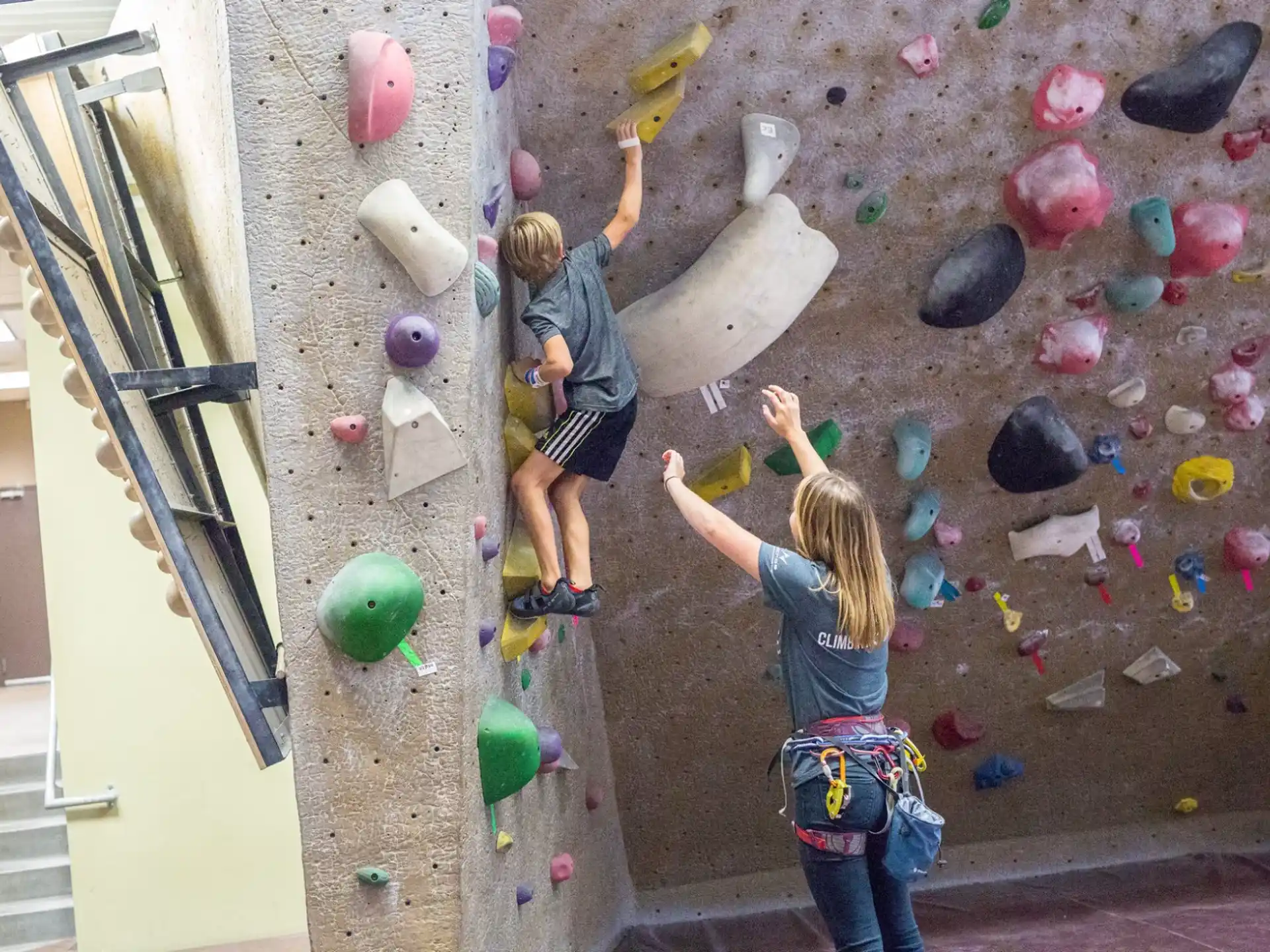 a group of people climbing a rock wall