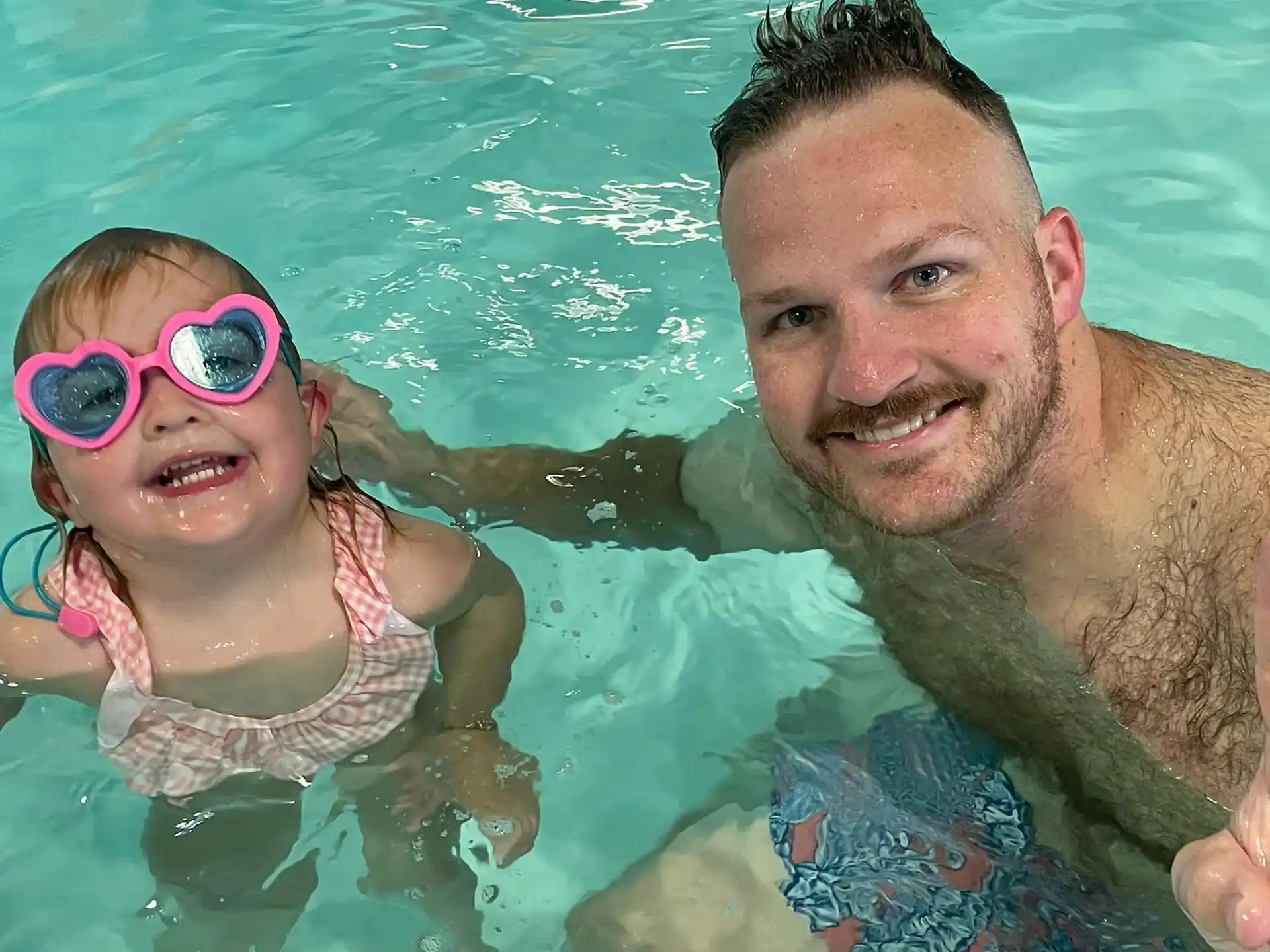 a man and a girl in a pool