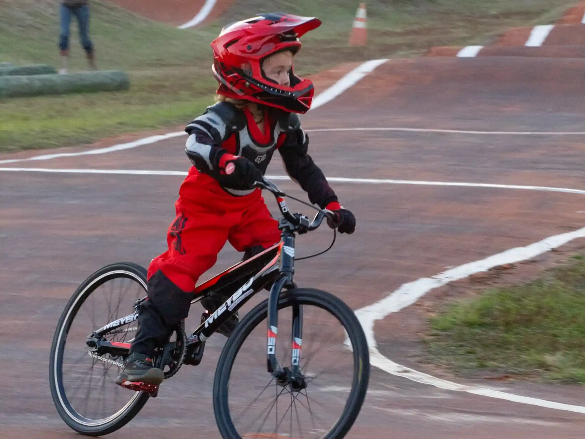 a boy riding a bicycle on a track