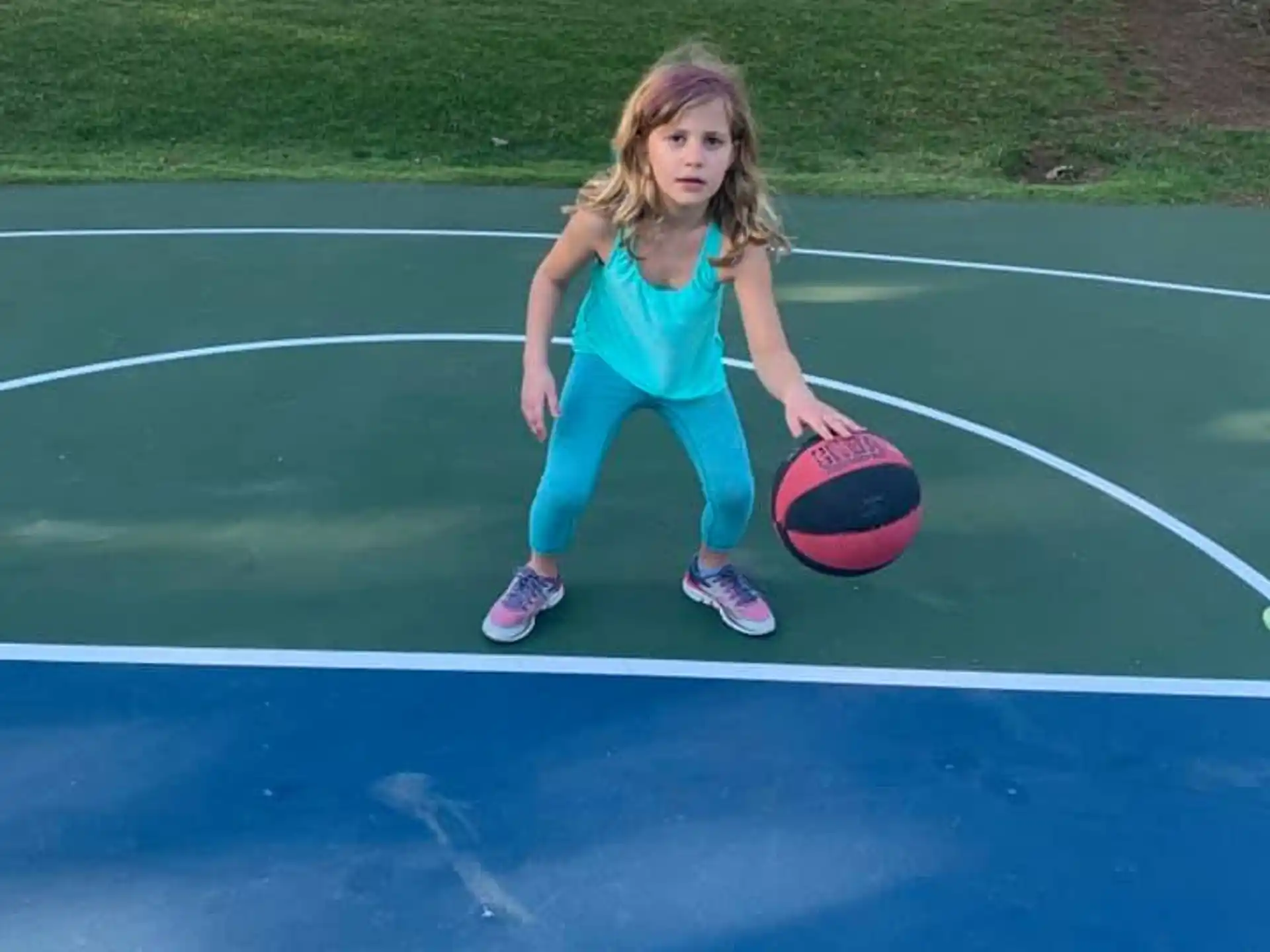 a girl holding a ball