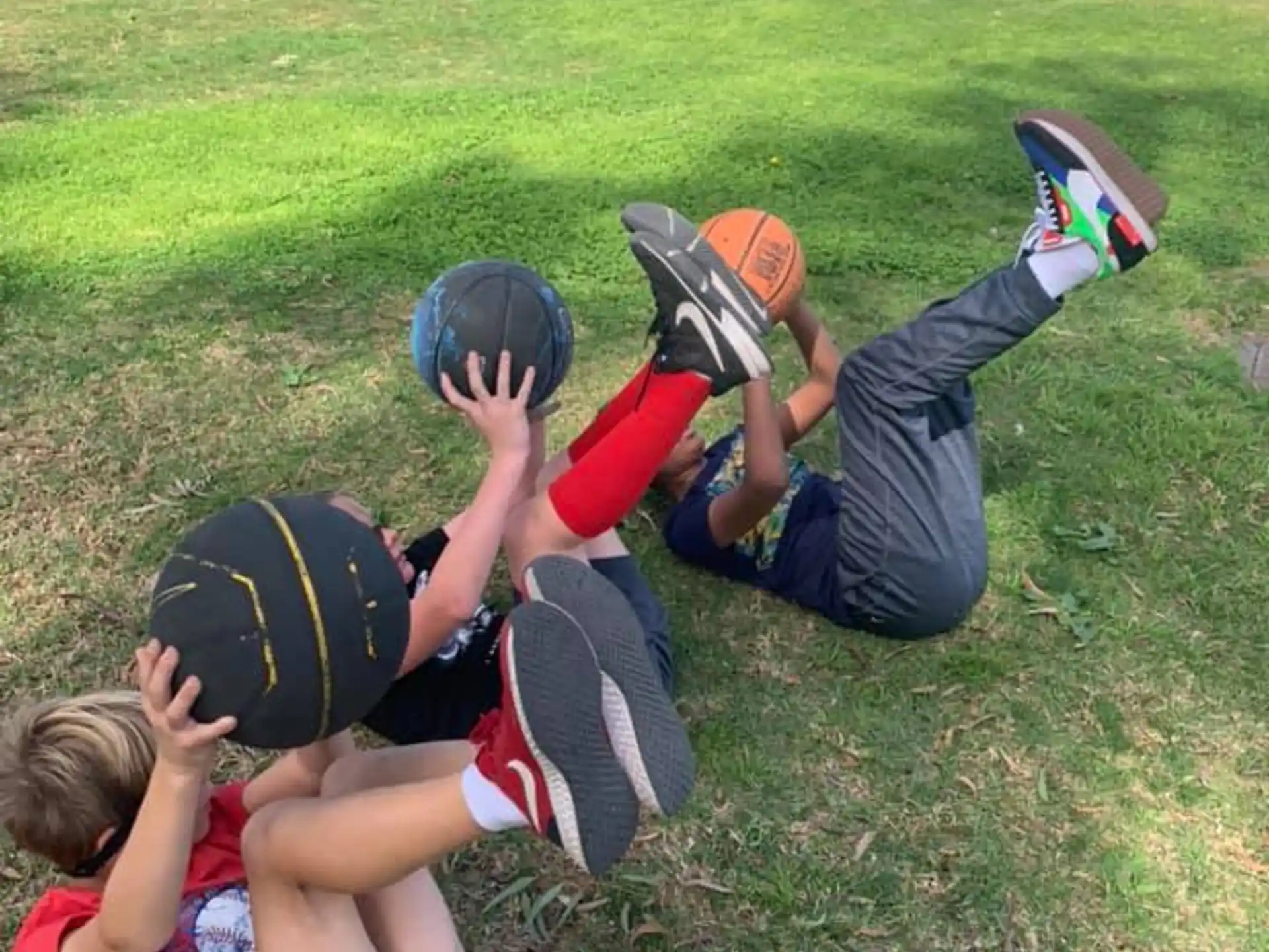 a group of kids playing in the grass