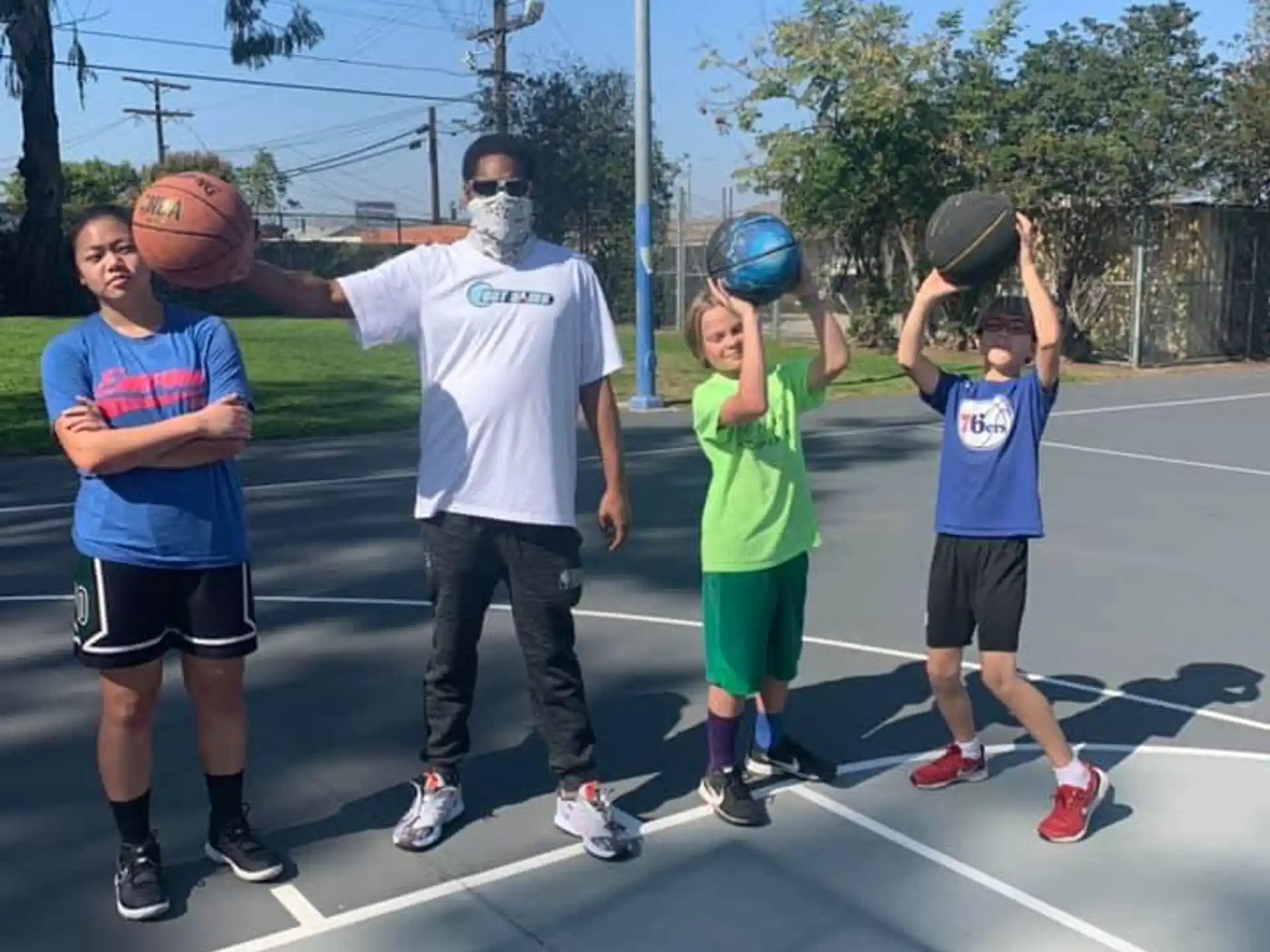 a group of people holding basketballs