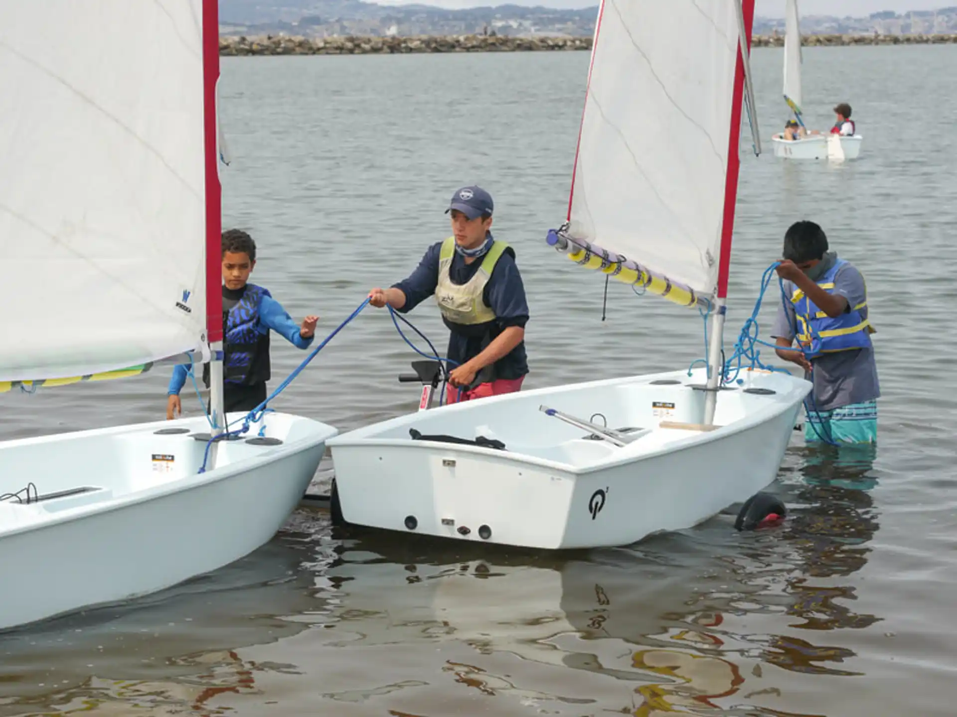 a group of people on a sailboat in the water