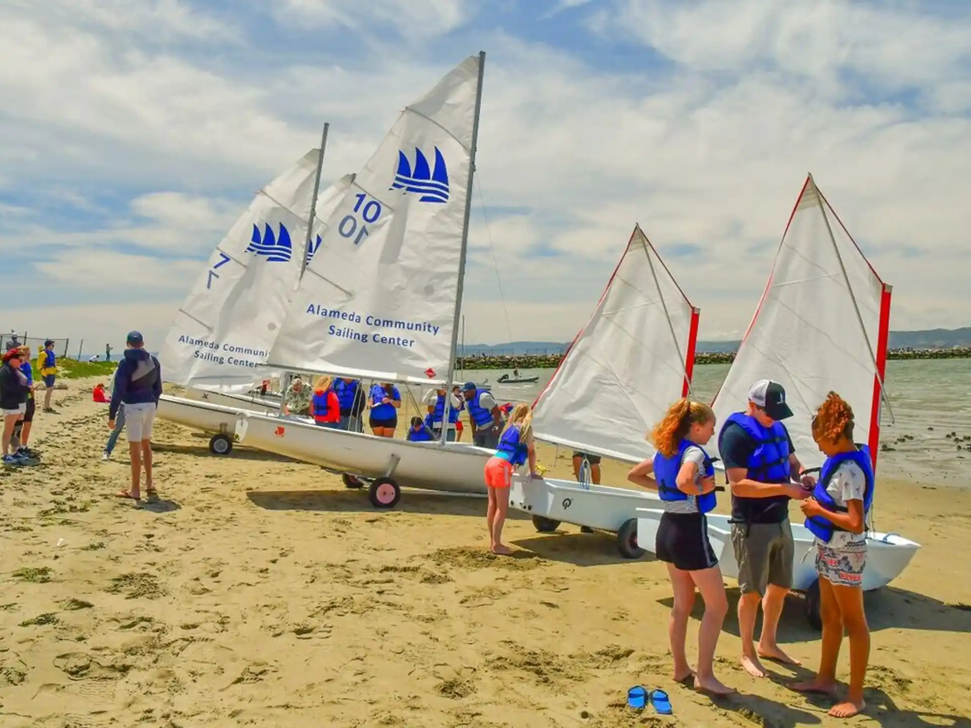 people standing near sailboats