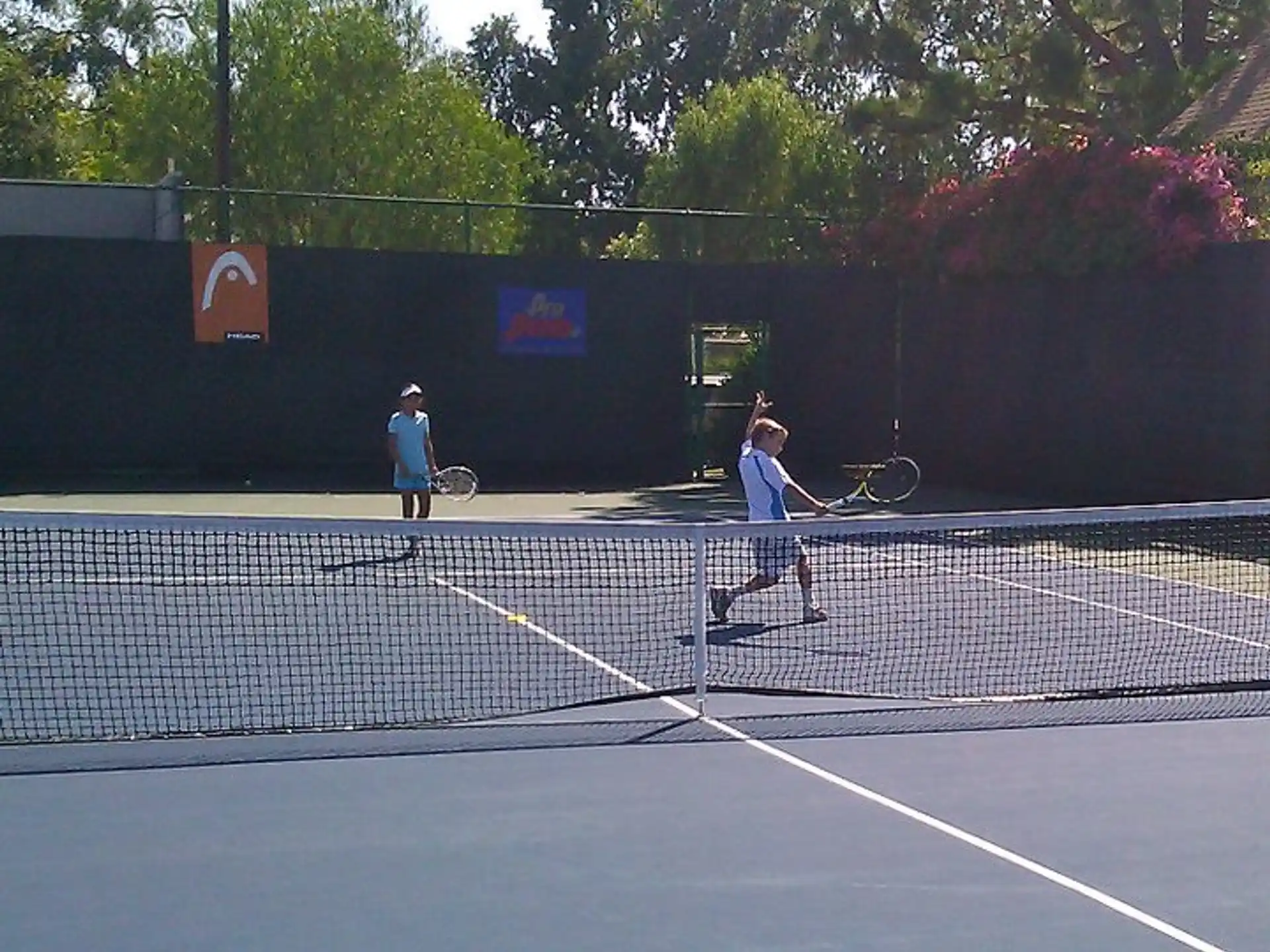 a couple of people play tennis