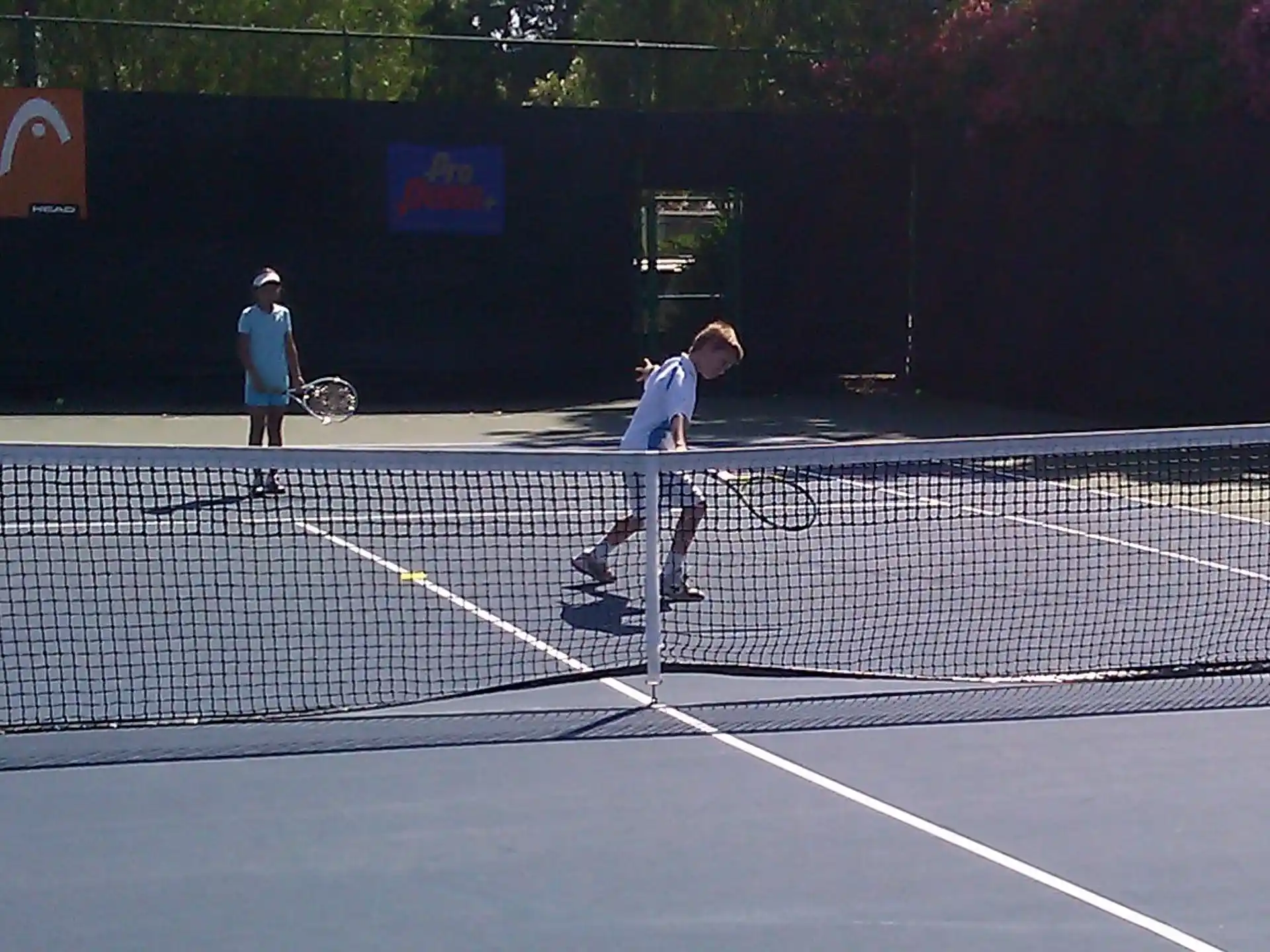 a couple of people play tennis