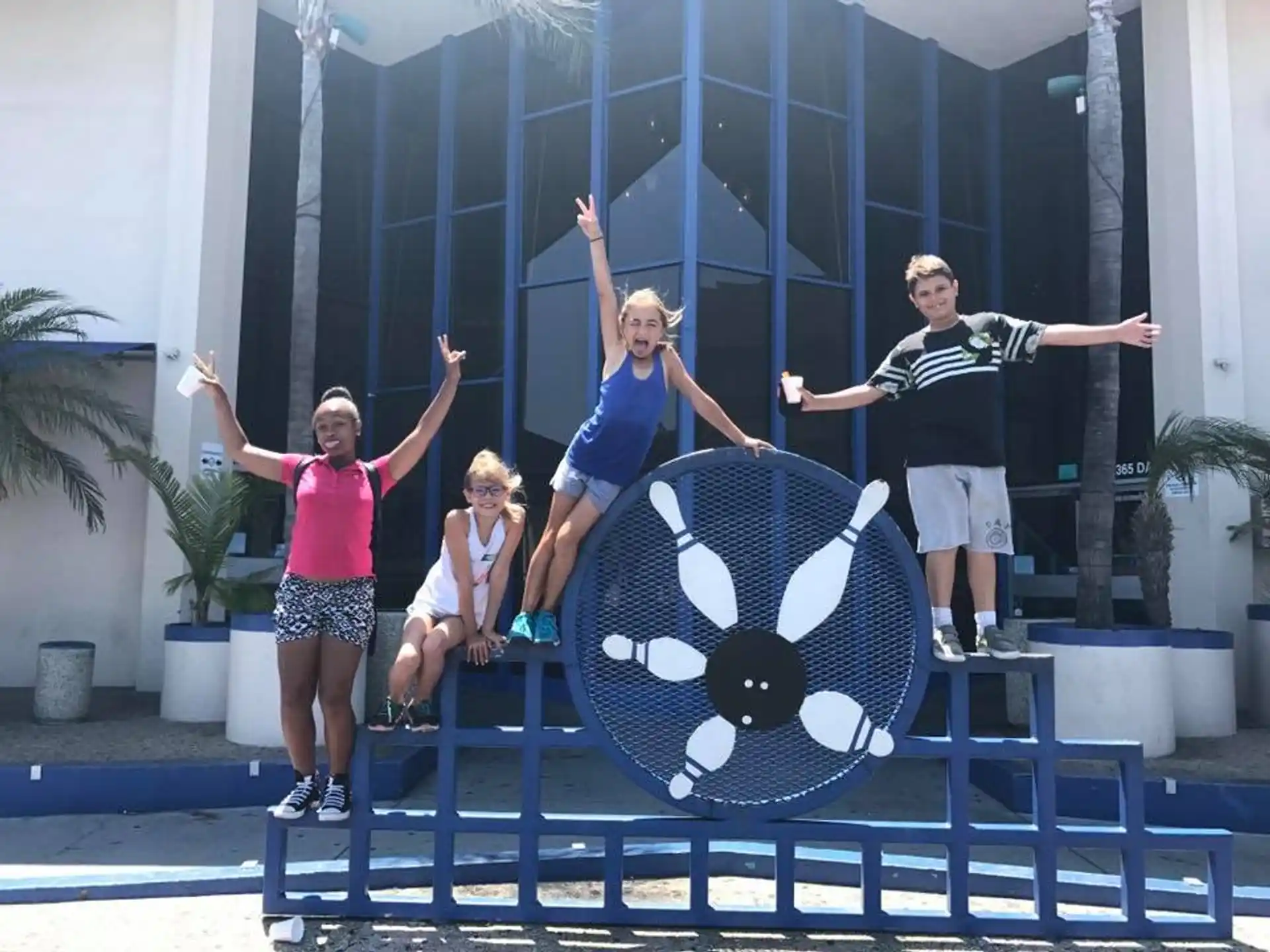 a group of people posing for a photo on a balcony