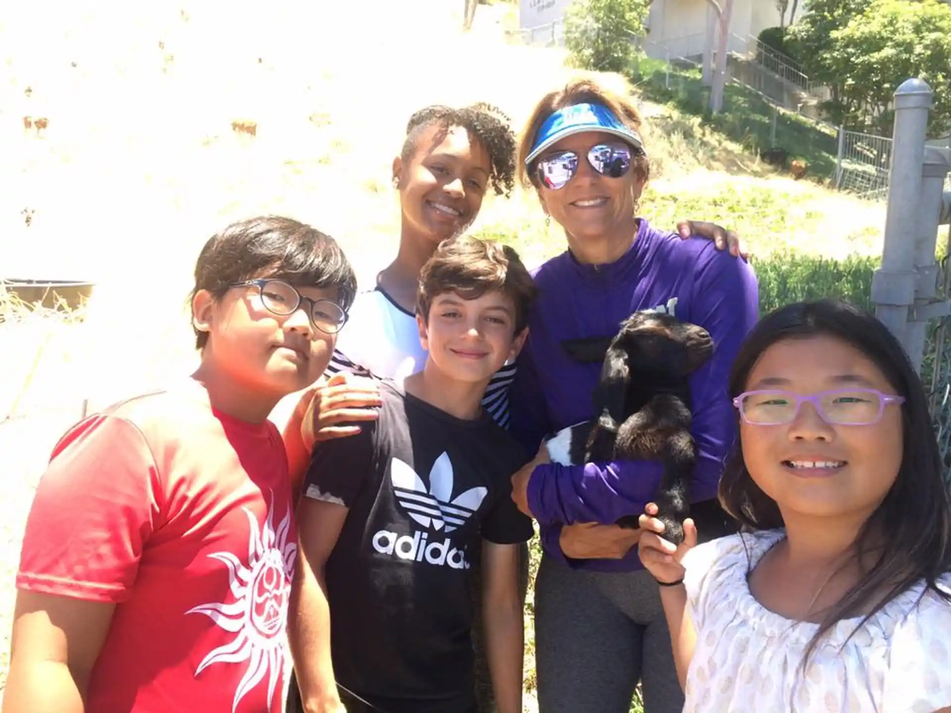 a group of people posing for a photo with a monkey