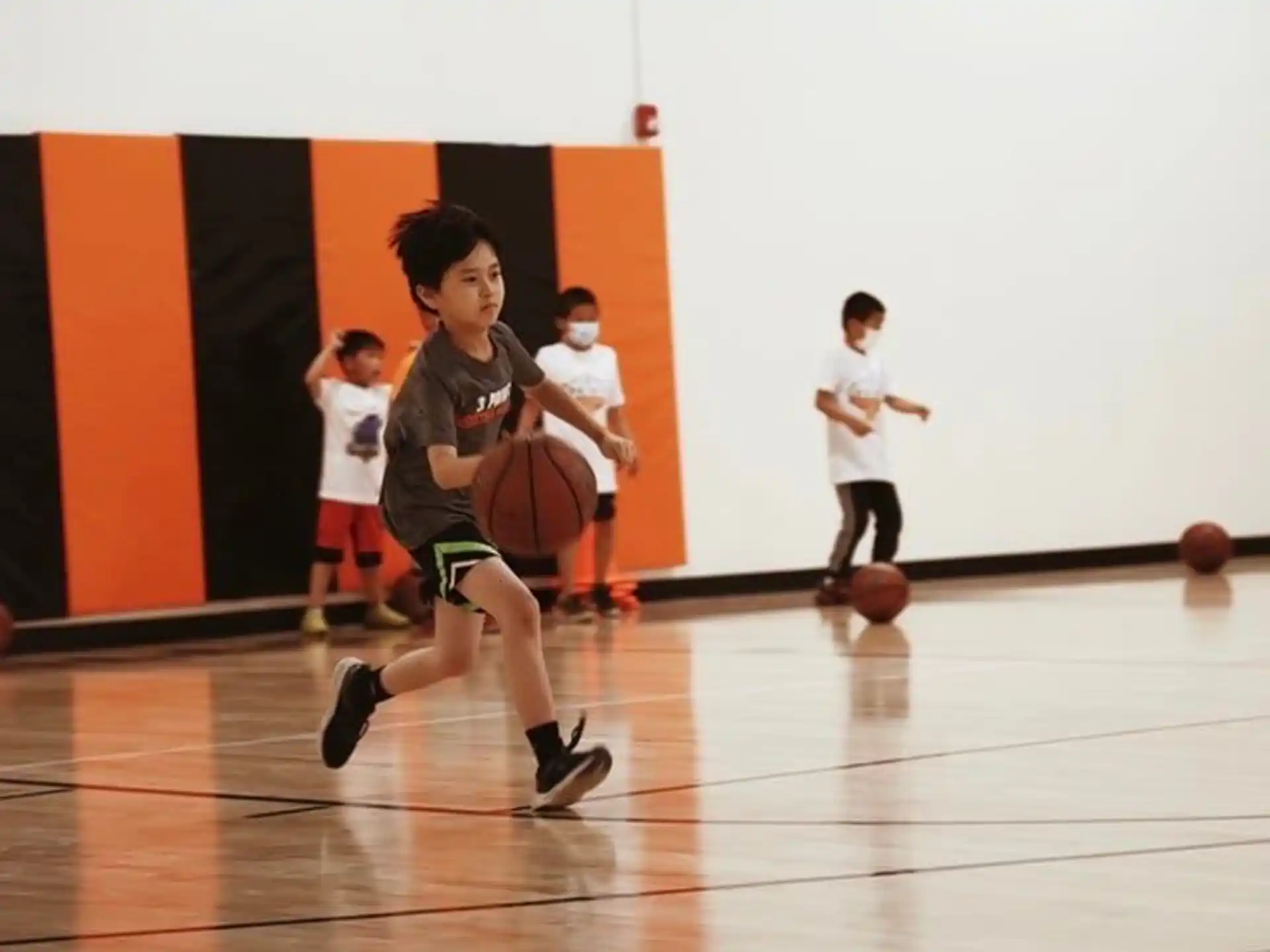 a group of kids playing basketball