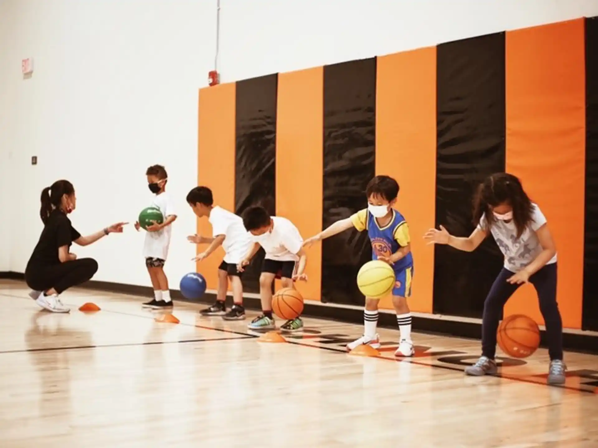 a group of kids playing basketball