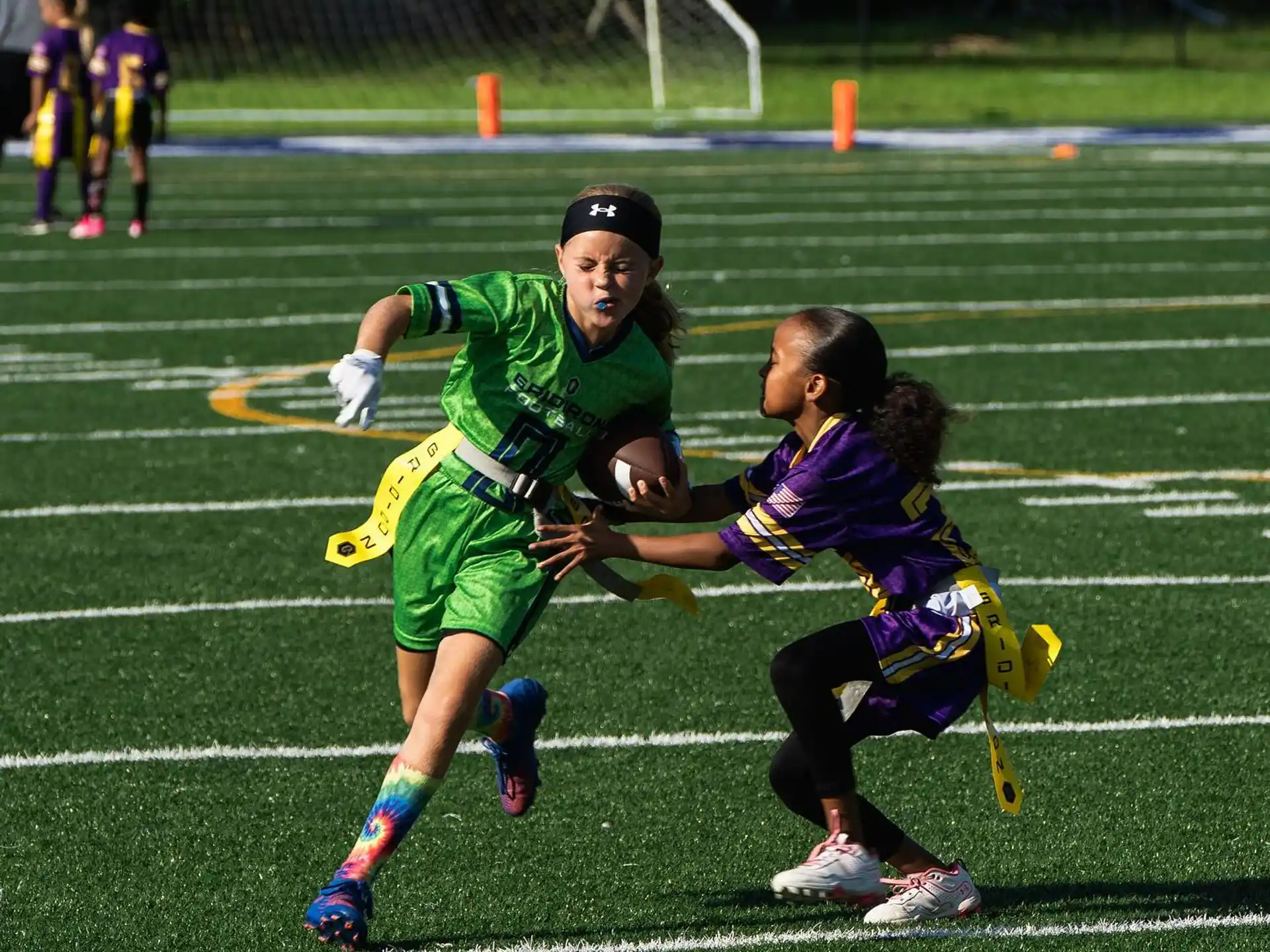 a group of kids playing football