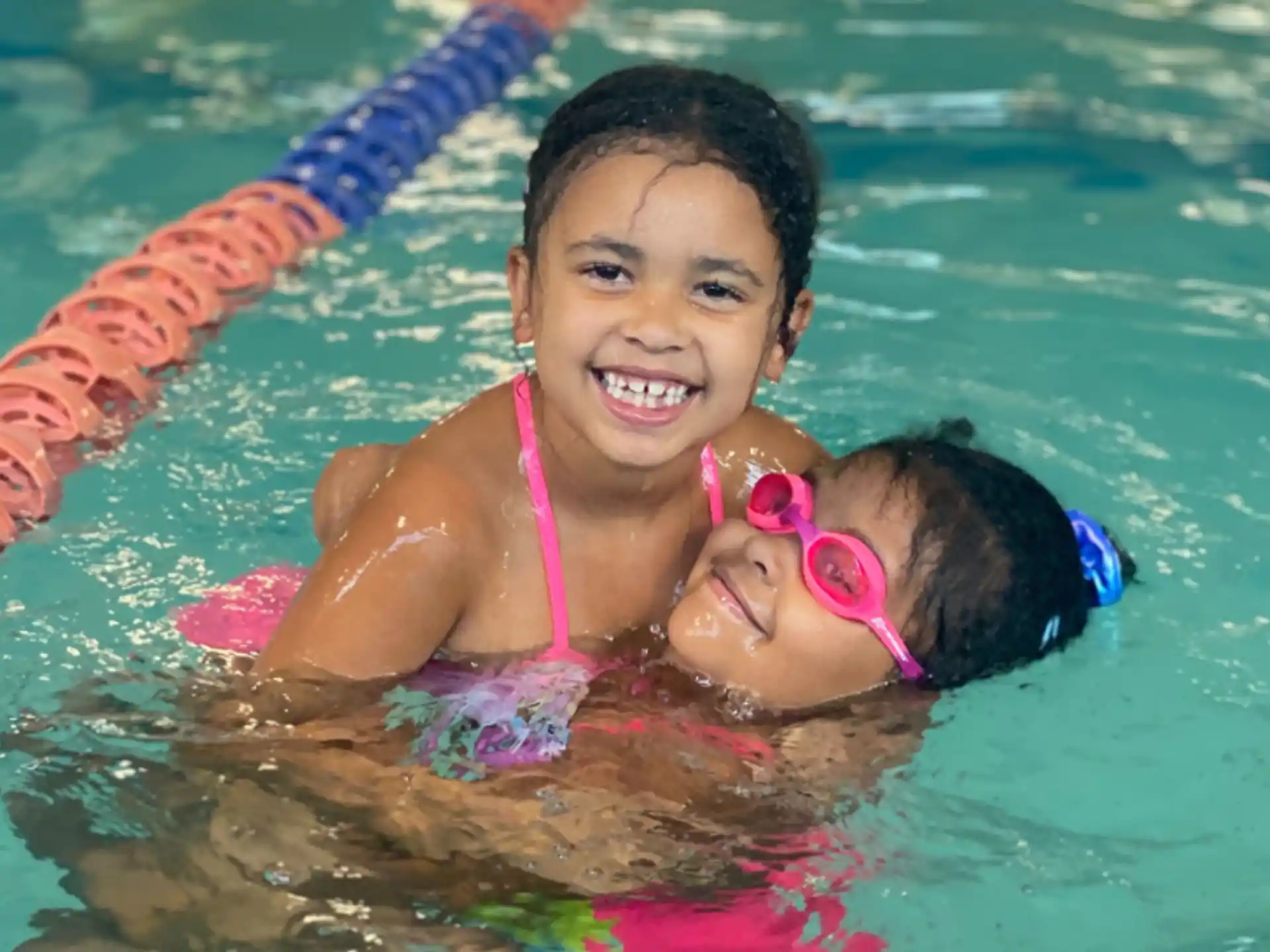 a girl and a baby in a pool