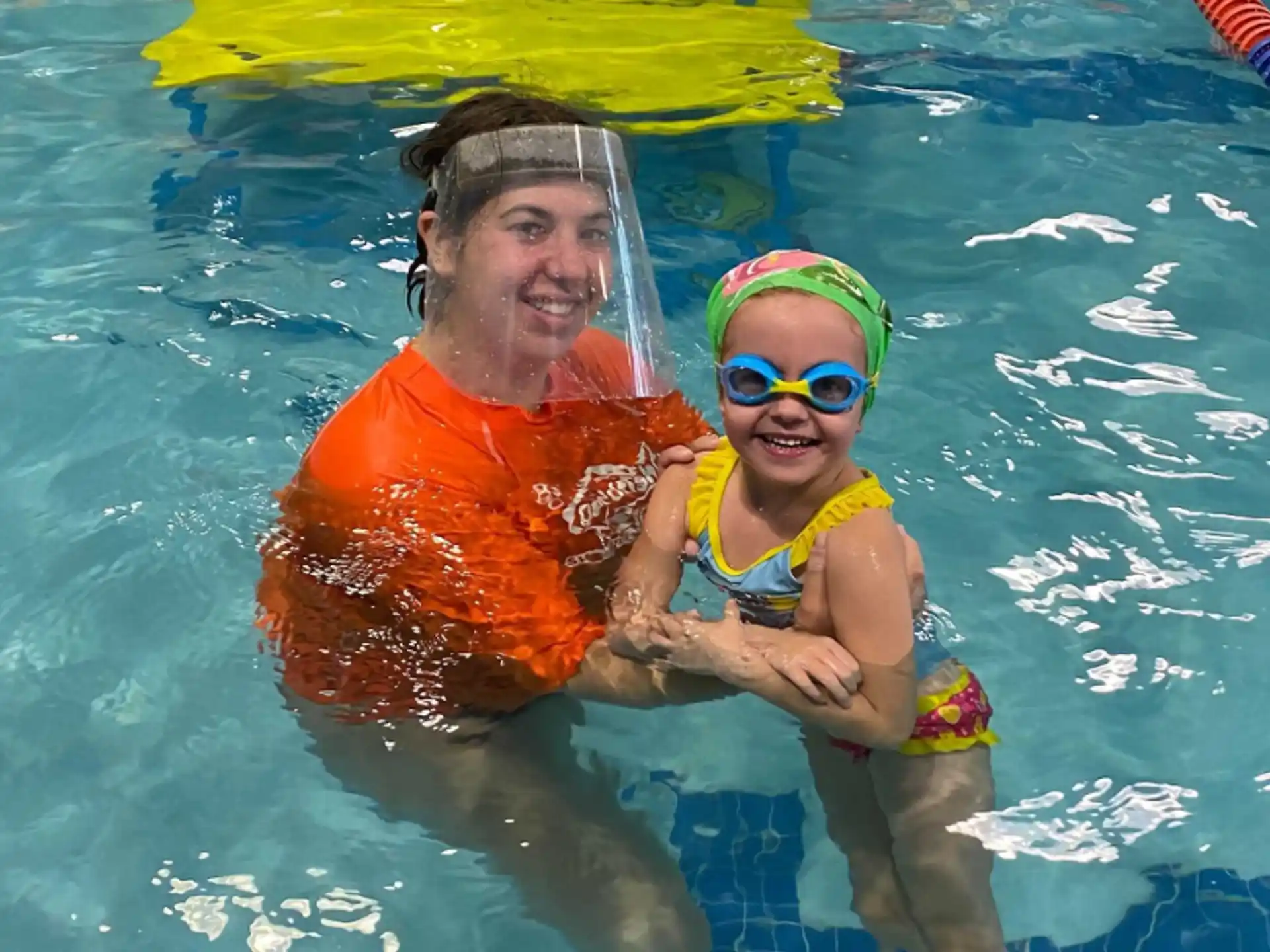 a man and a child in a pool