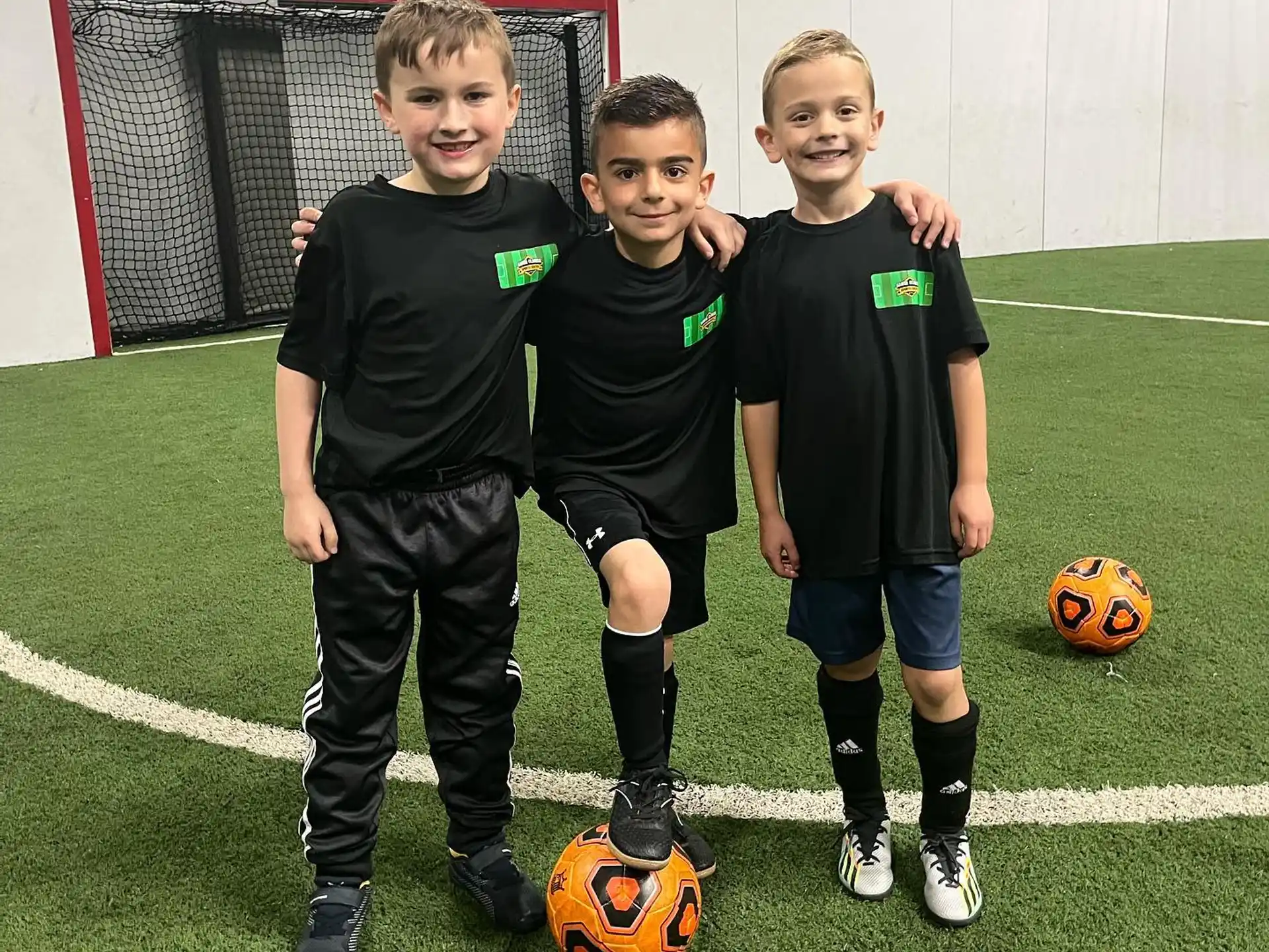 a group of boys posing for a picture with a football ball