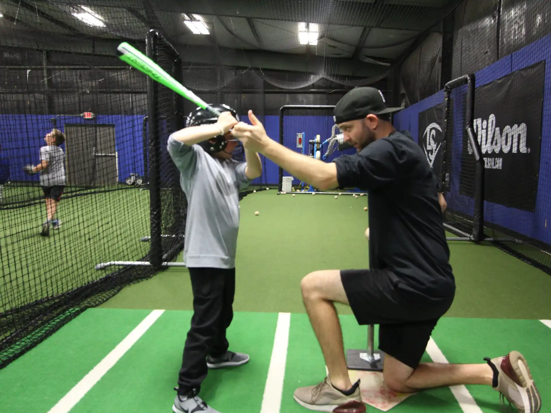 a person hitting a ball with a baseball bat