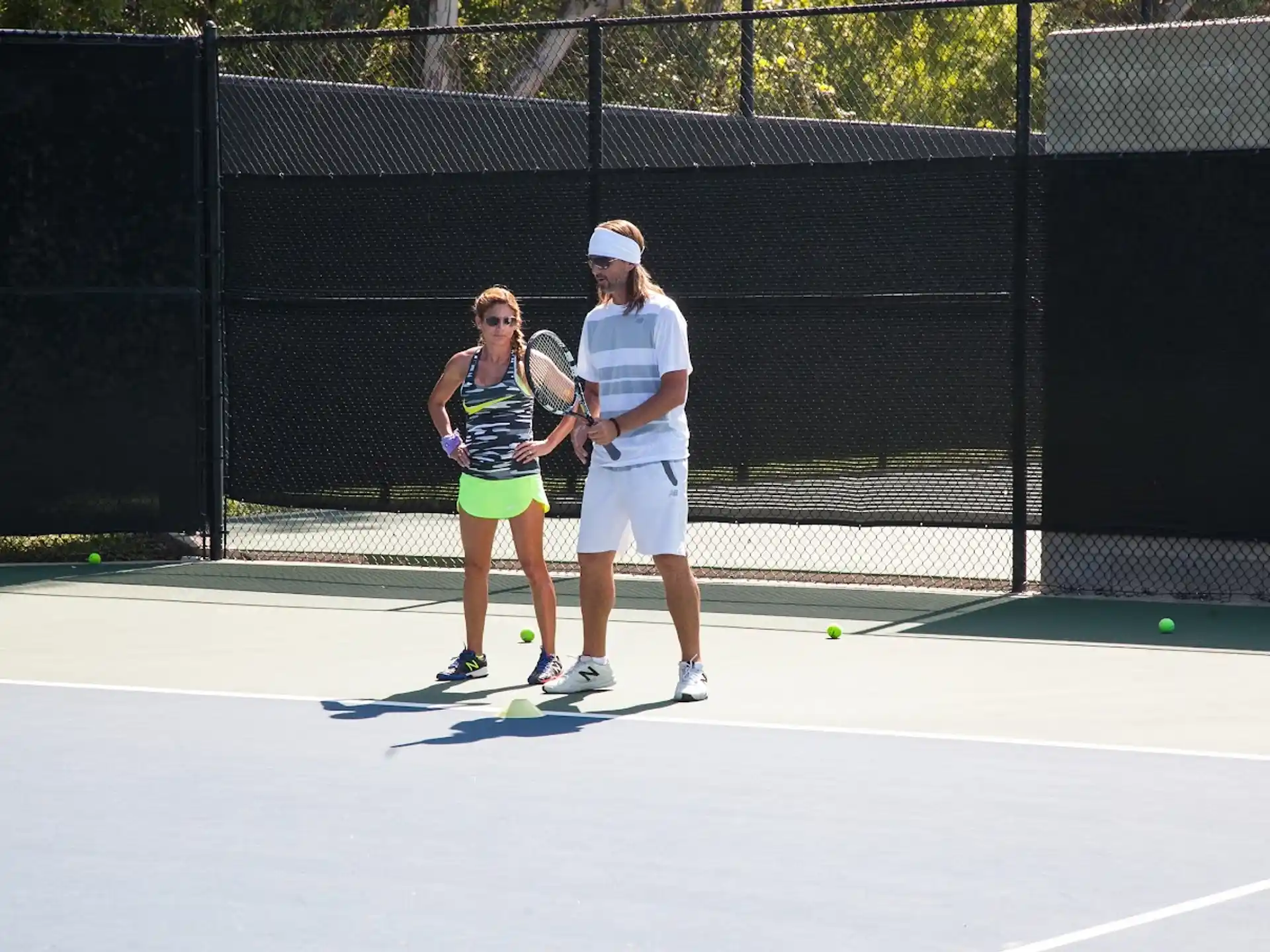 a couple of people play tennis