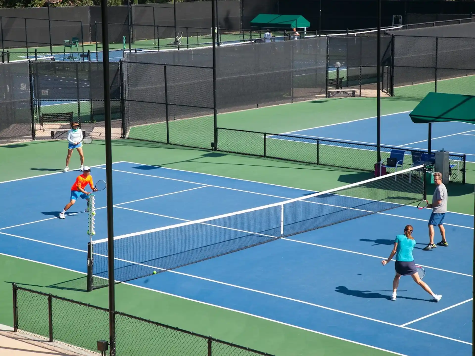 a group of people play tennis