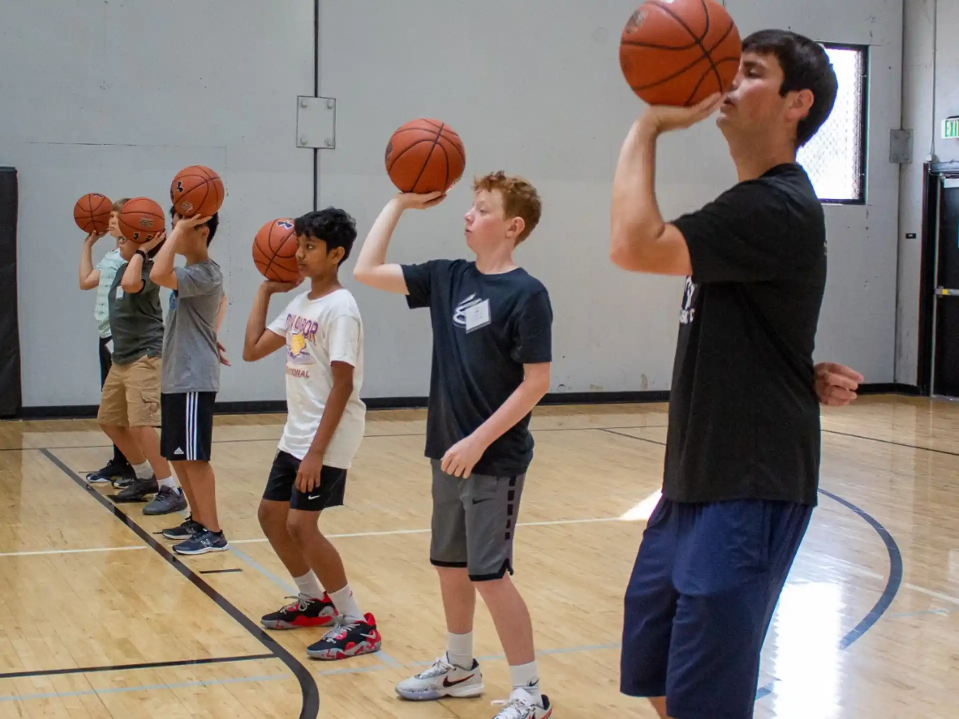 a group of kids playing basketball