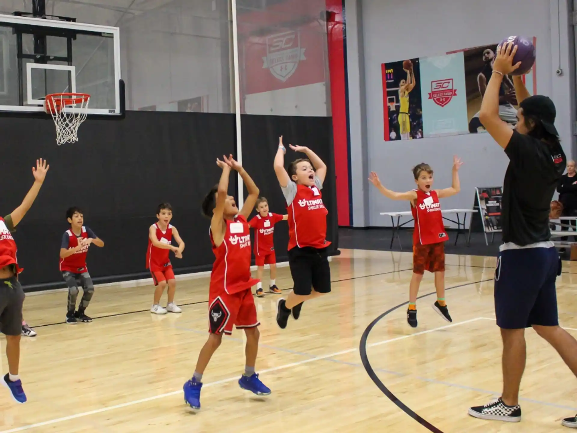 a group of kids playing basketball