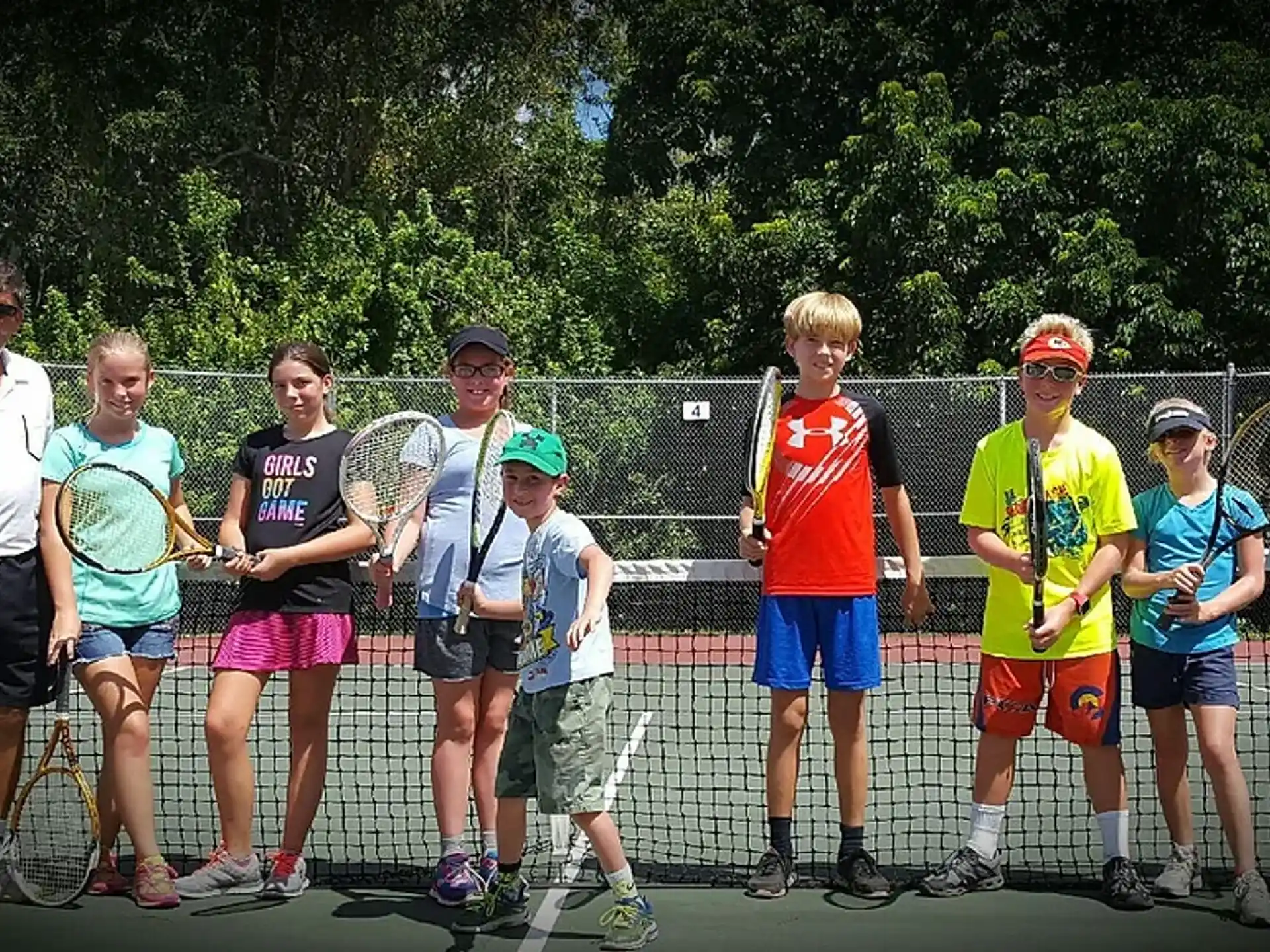 a group of people holding tennis rackets