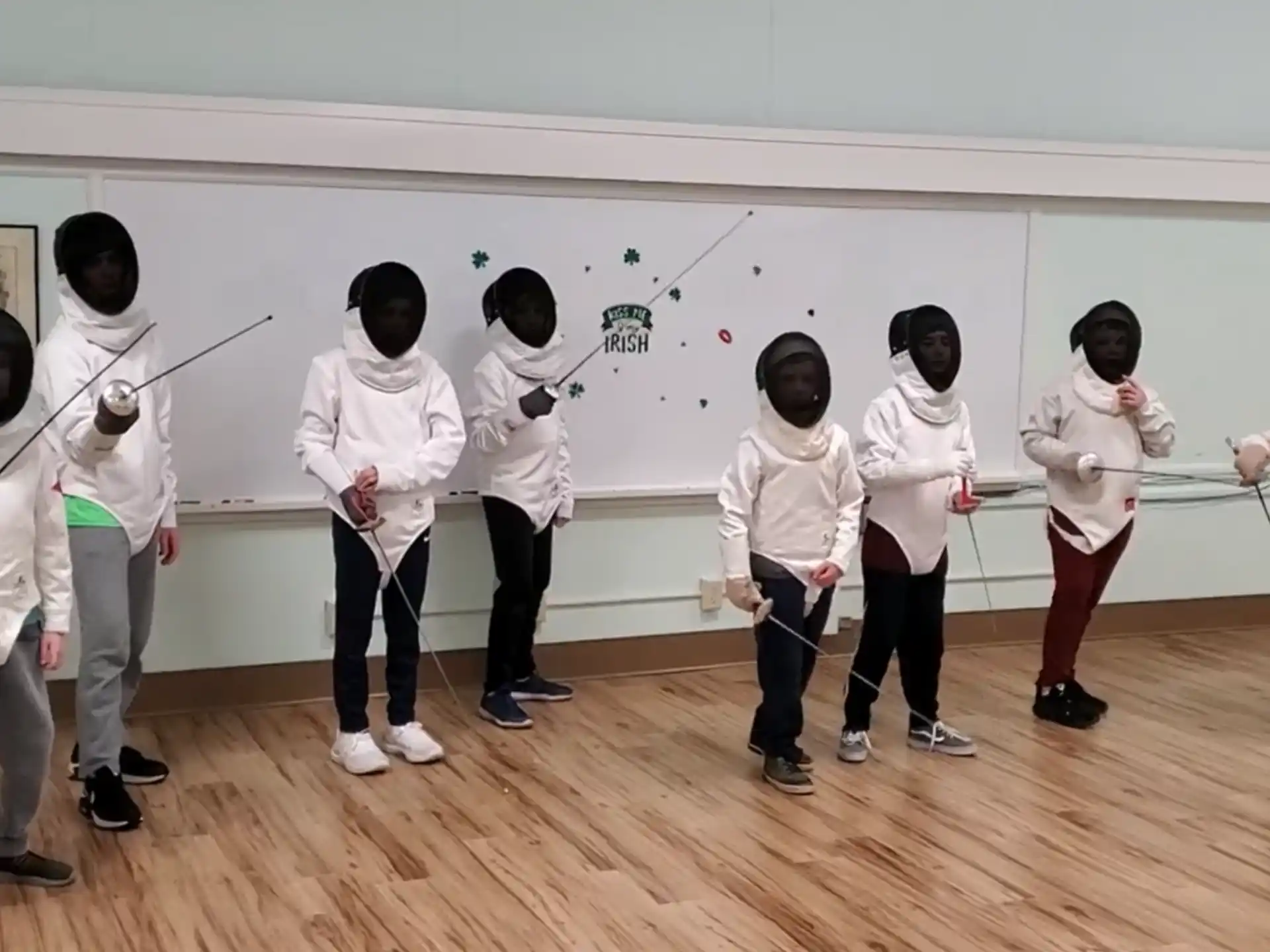 a group of people in white karate uniforms