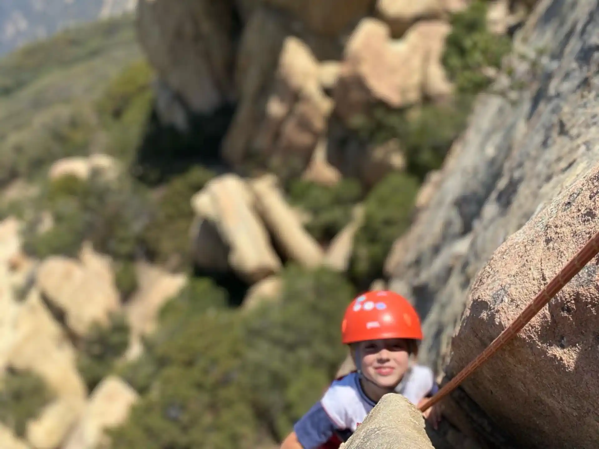 a boy climbing a rock wall