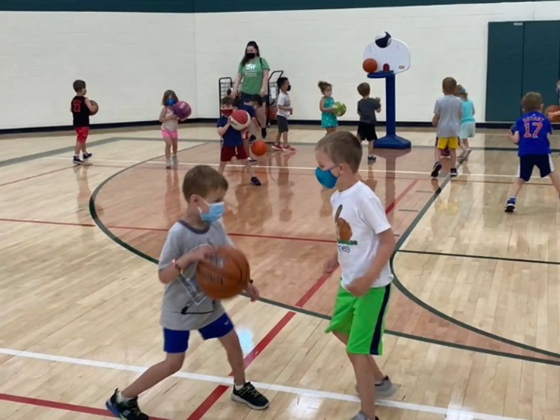 a group of kids playing basketball