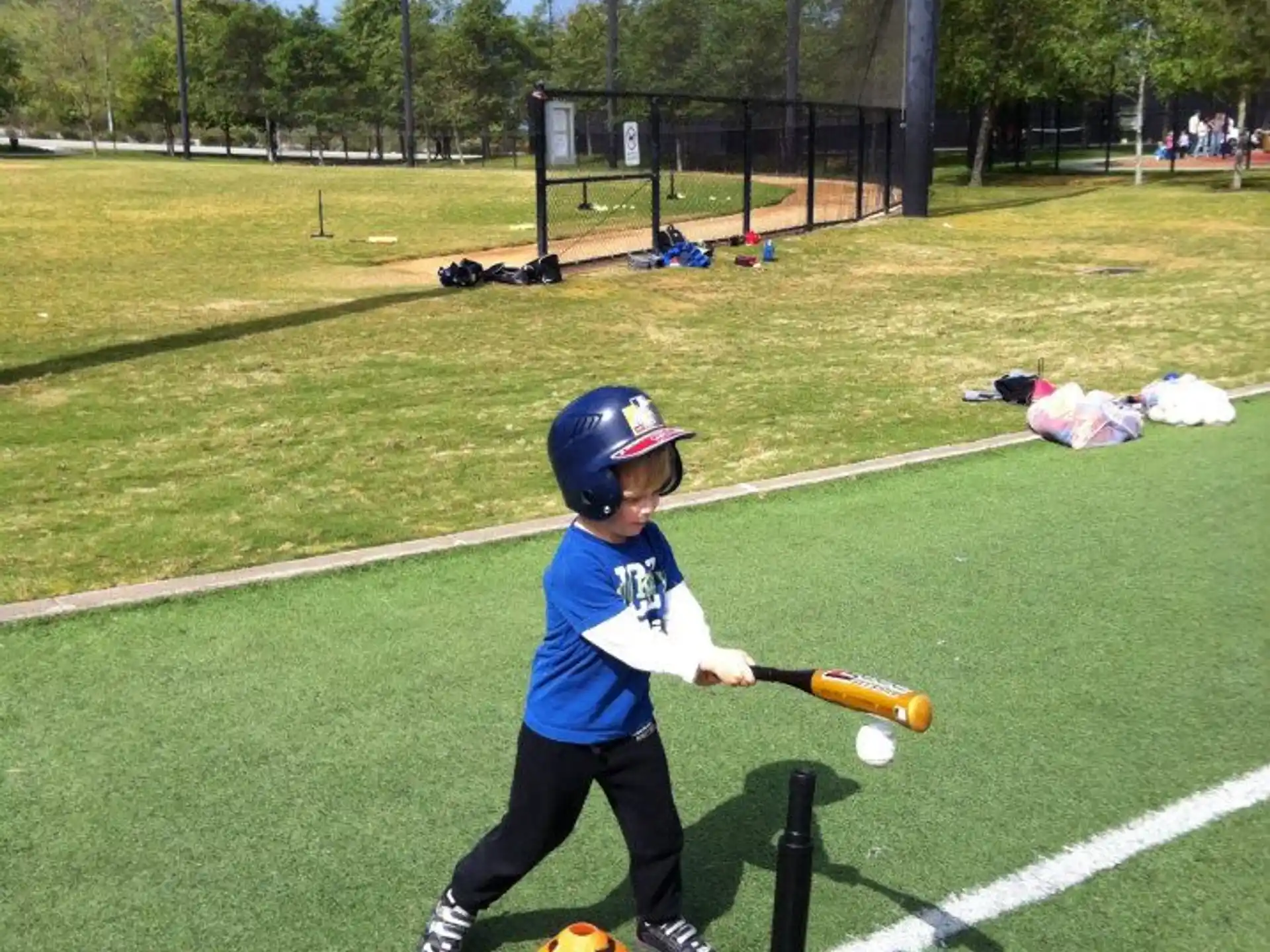 a kid swinging a baseball bat